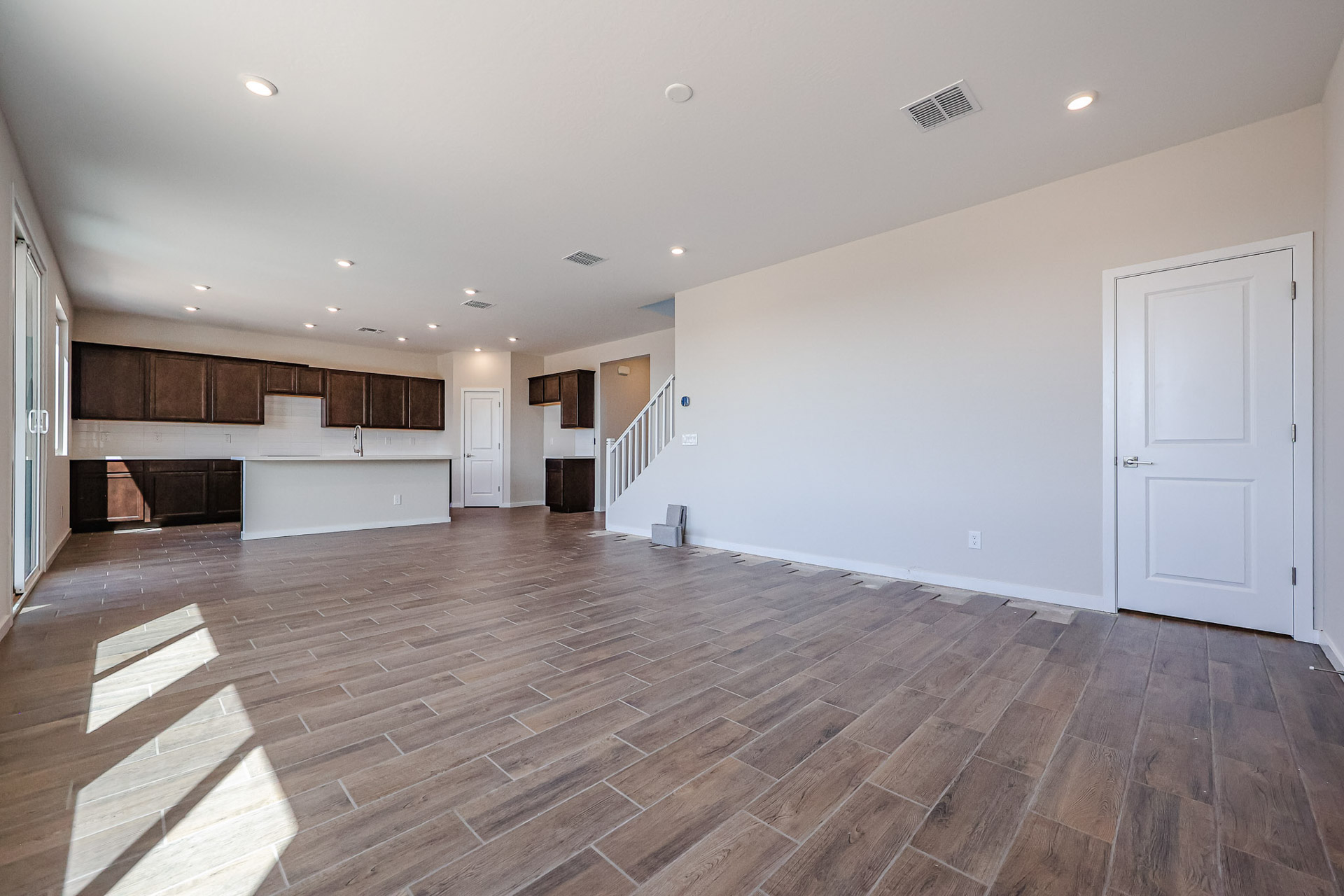 A large empty room with white doors.