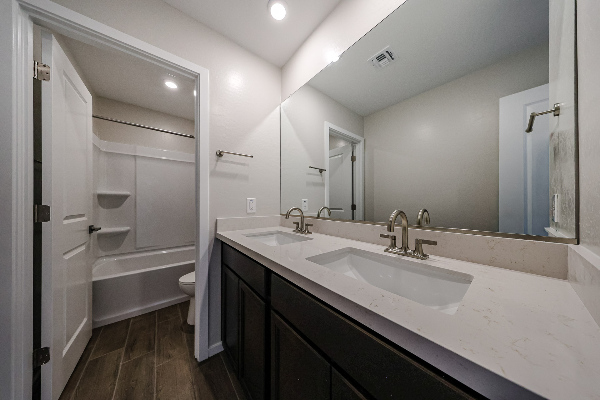 A bathroom with a tub sink and a toilet.