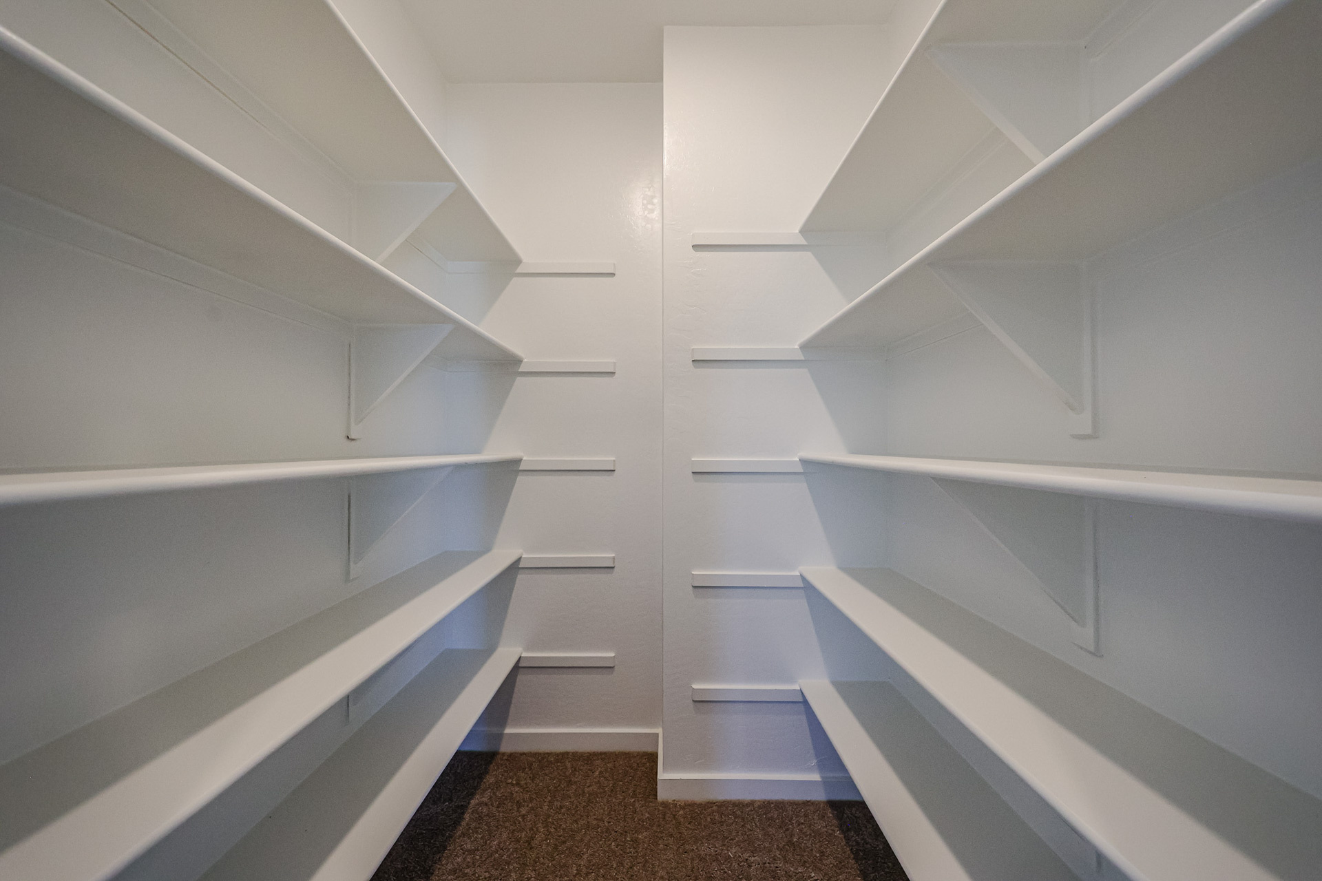 A white staircase with white walls.