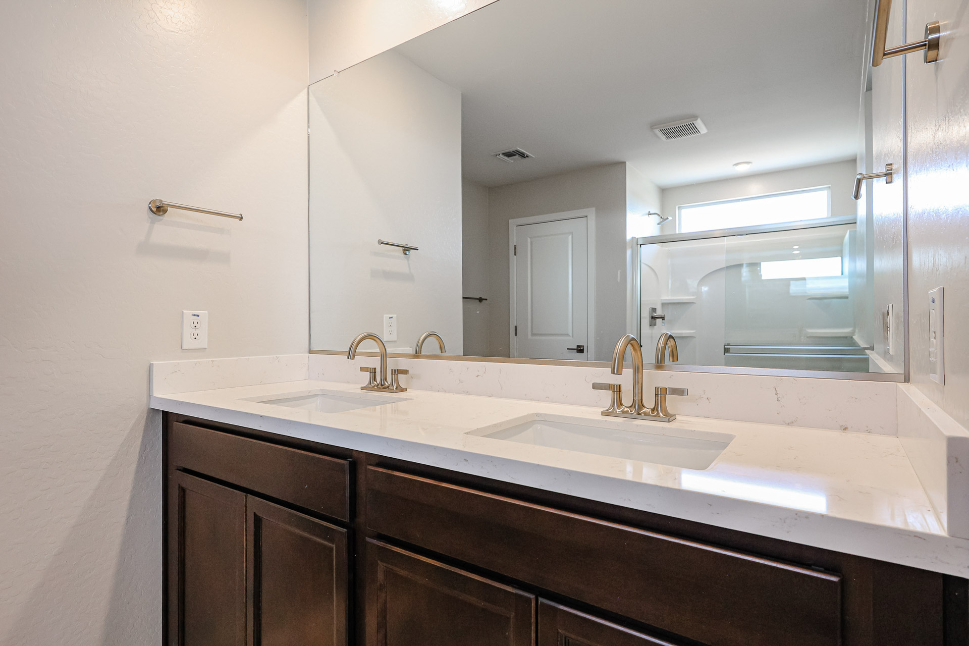 A bathroom with a large mirror.