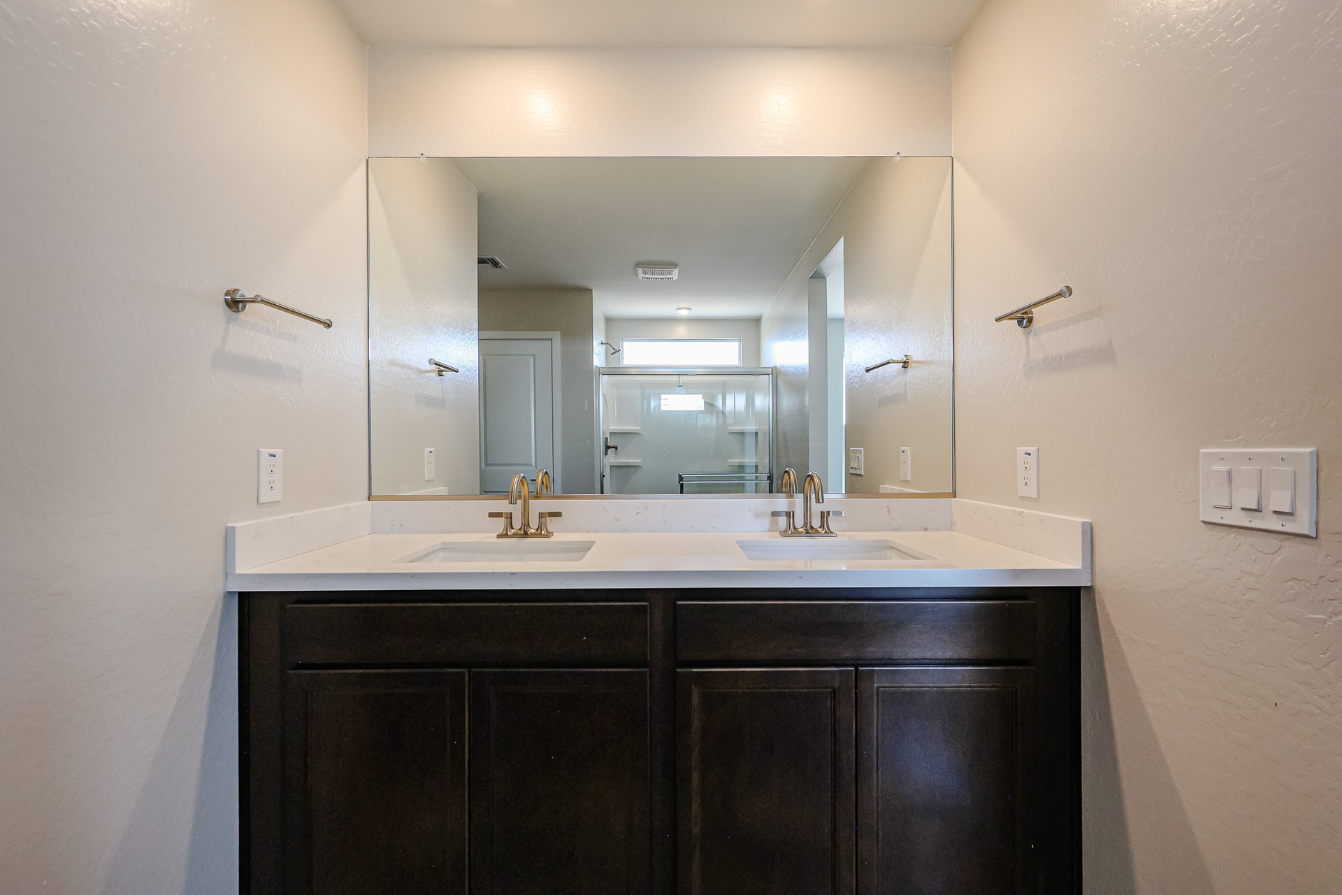 A bathroom with a large mirror.
