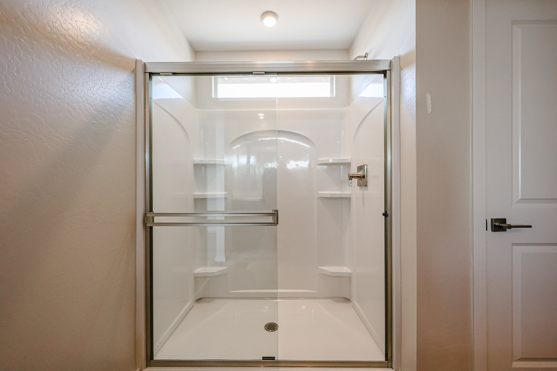 A shower with a glass door.