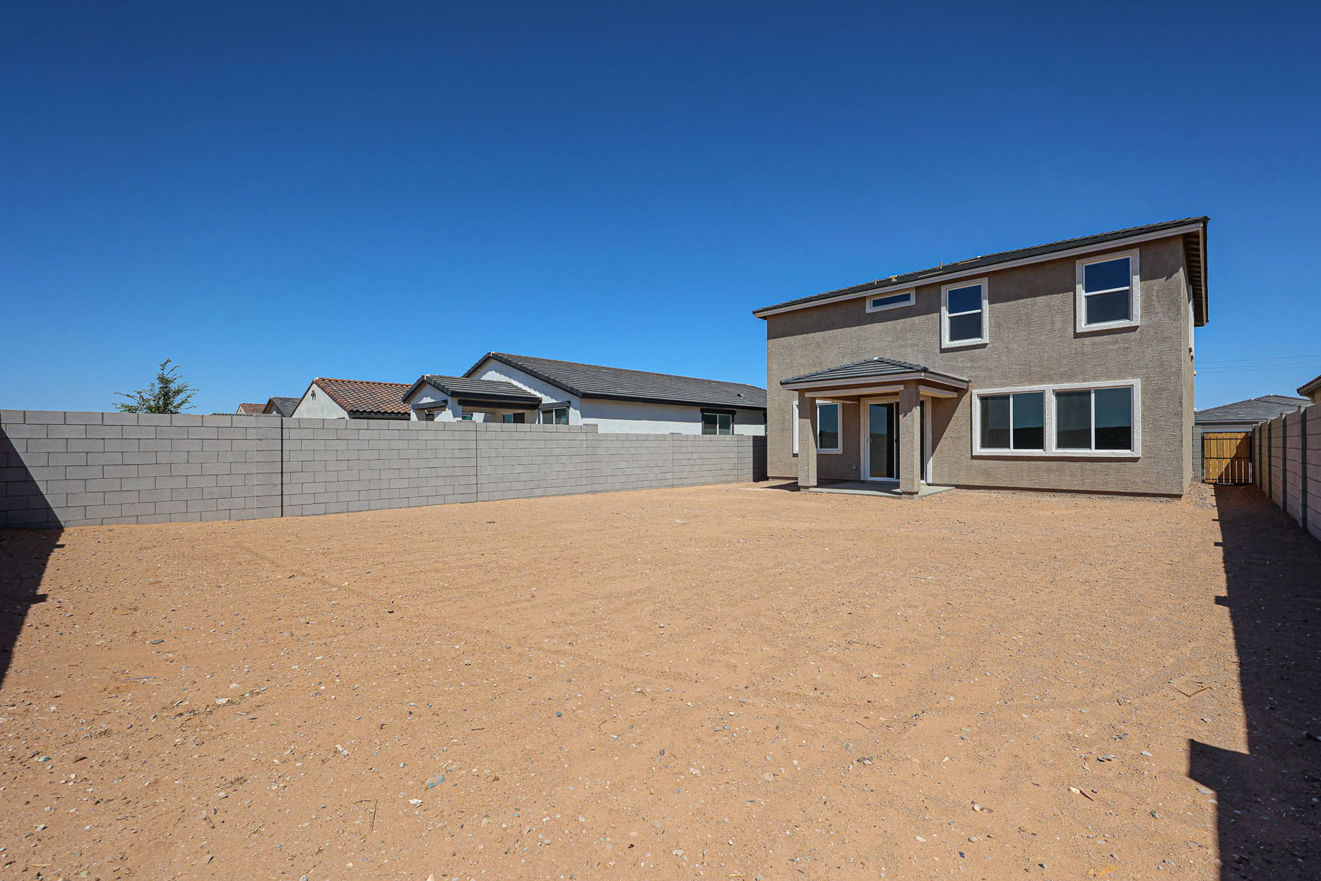 A house with a dirt yard.