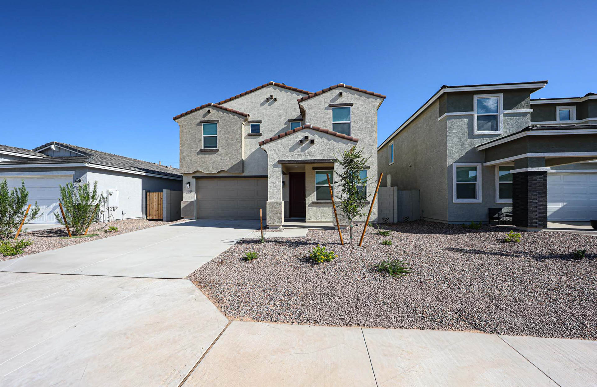 A house with a gravel driveway.