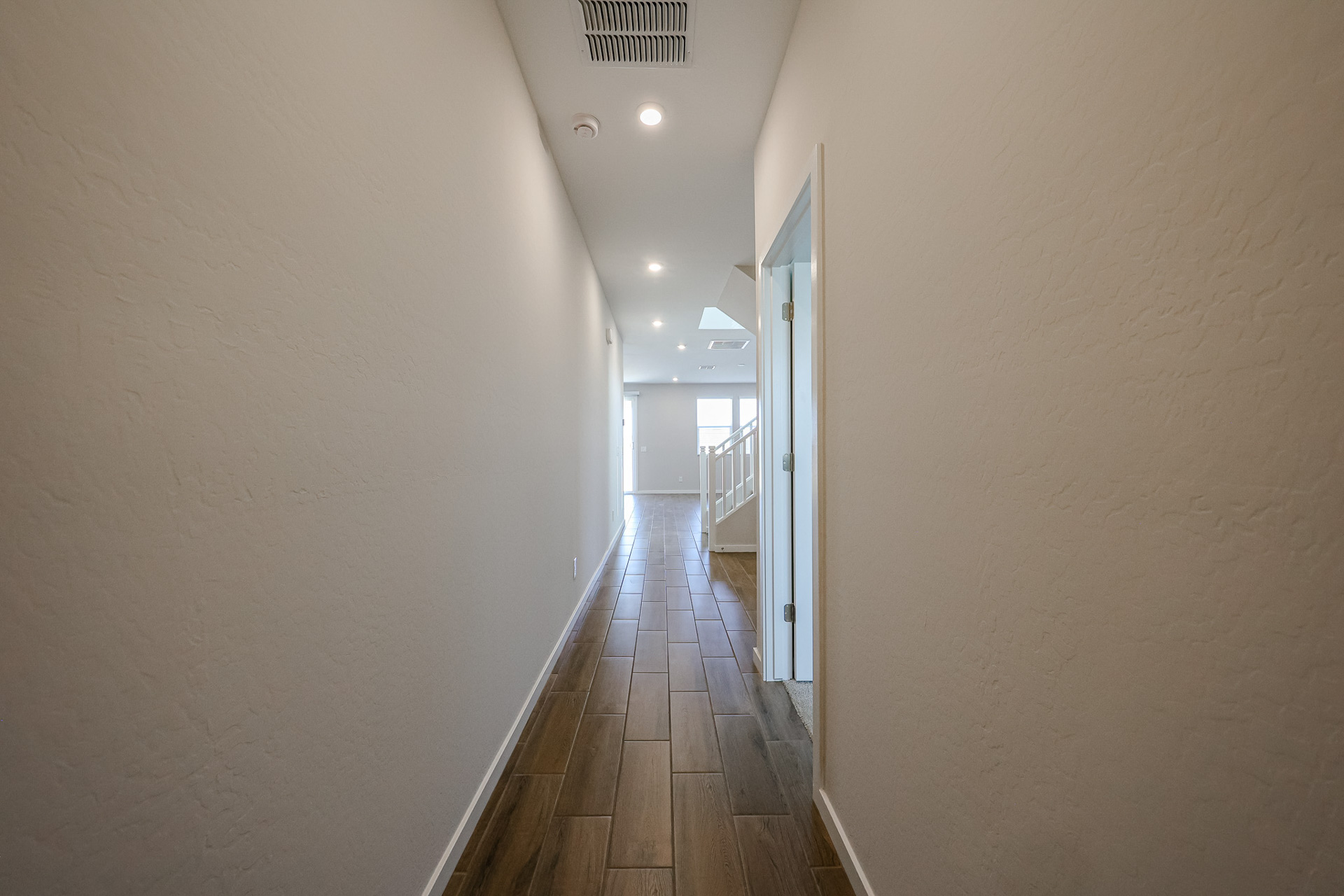 A long hallway with white walls.