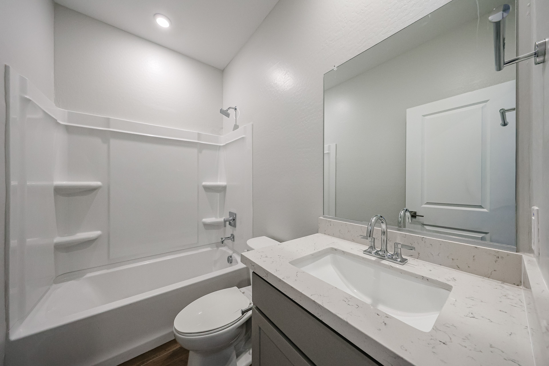 A bathroom with a tub sink and toilet.