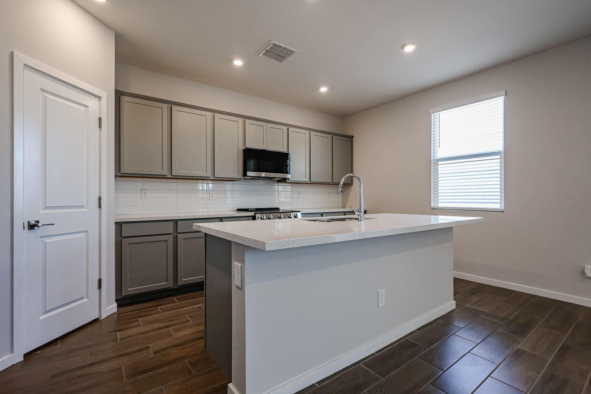 A kitchen with white cabinets.