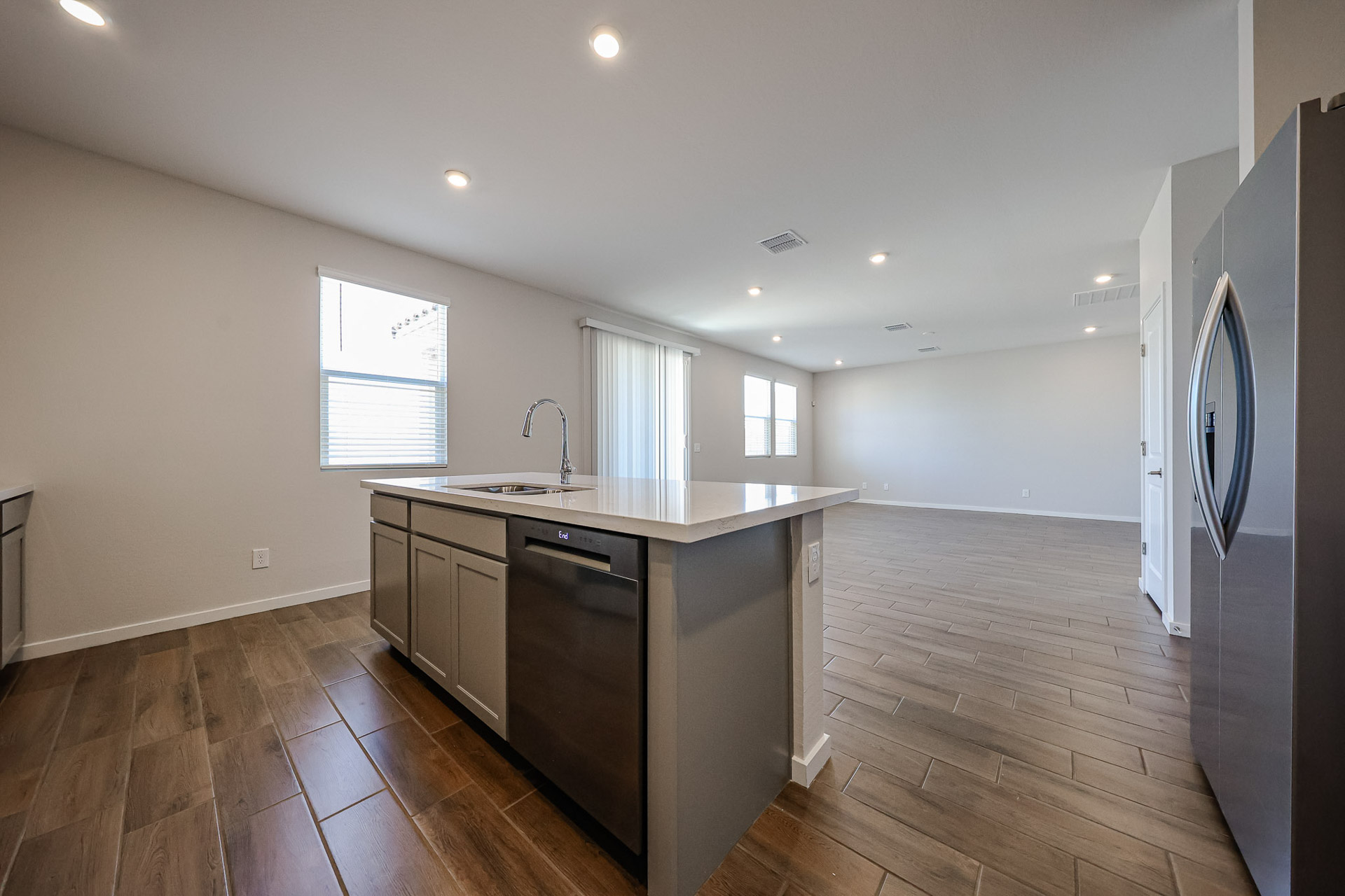 A kitchen with a wood floor.
