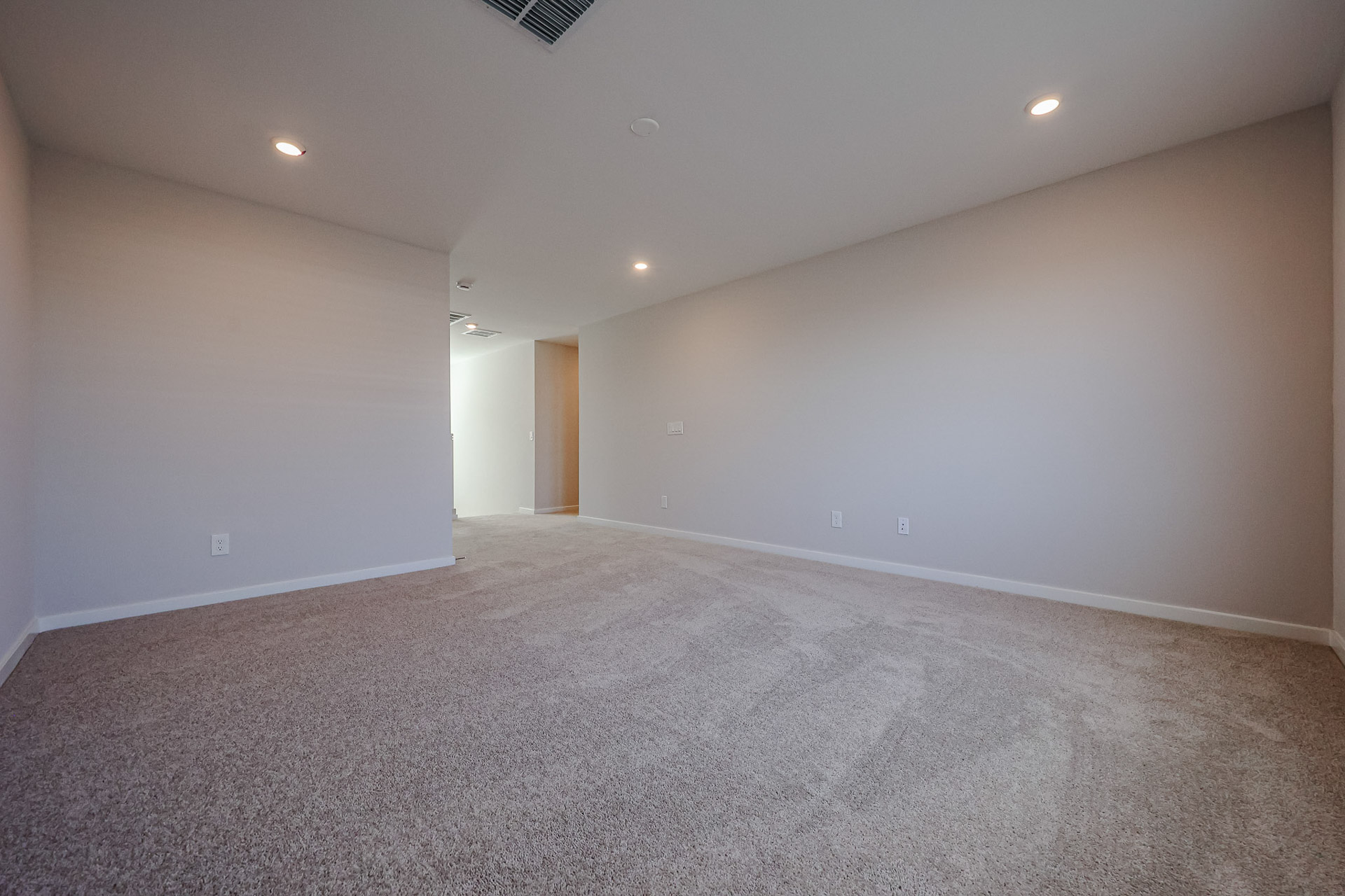 A room with a carpet and a carpet.
