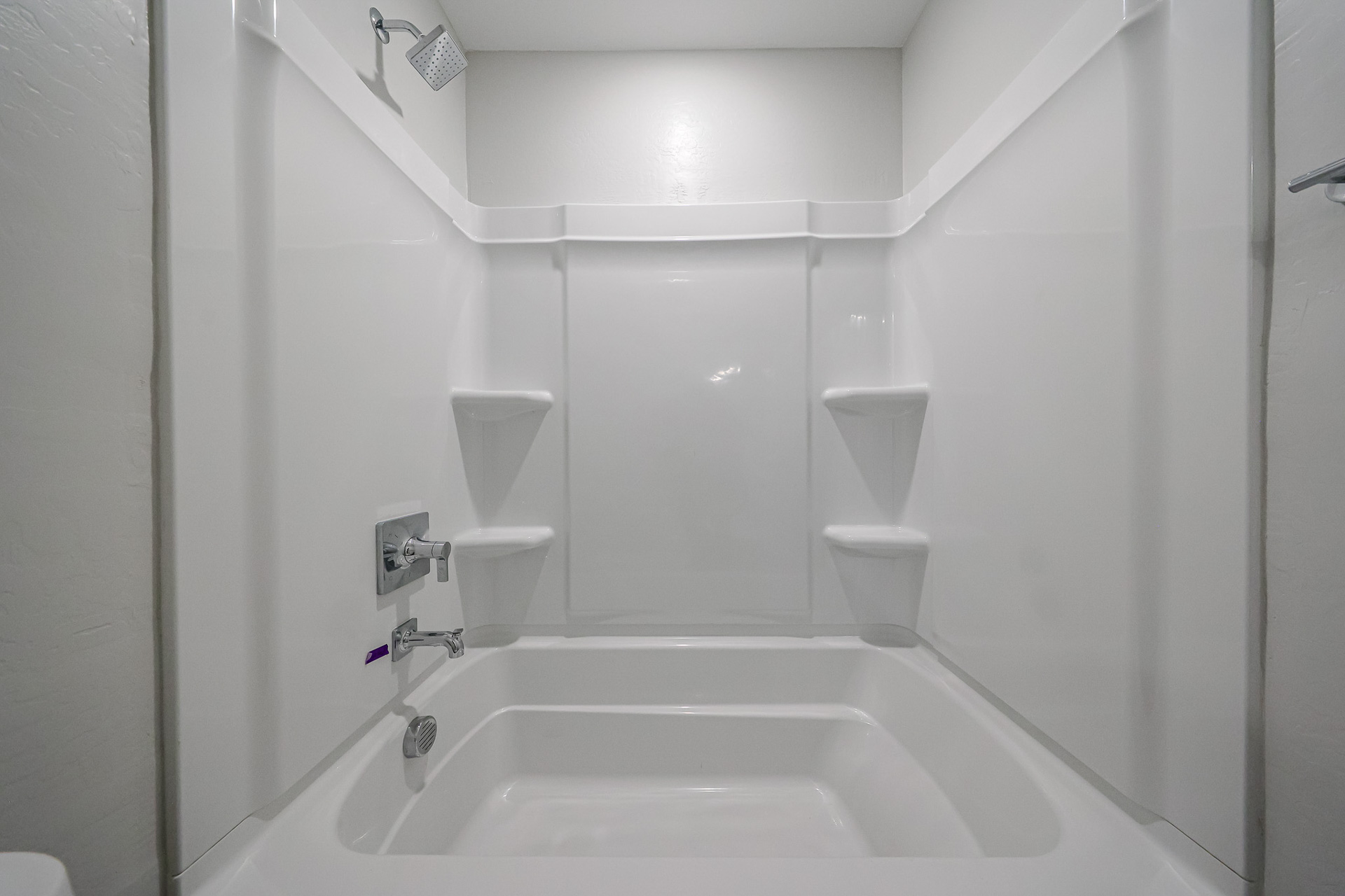 A bathroom with a tub and toilet.