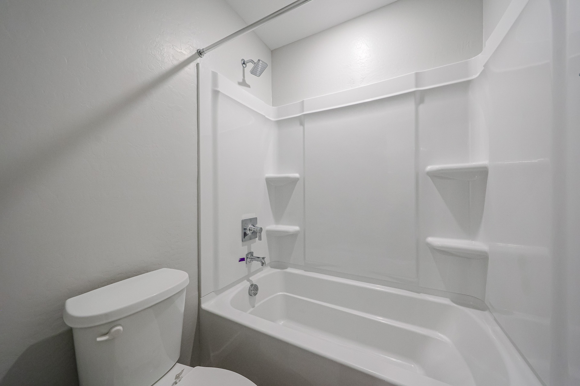 A bathroom with a tub toilet and sink.