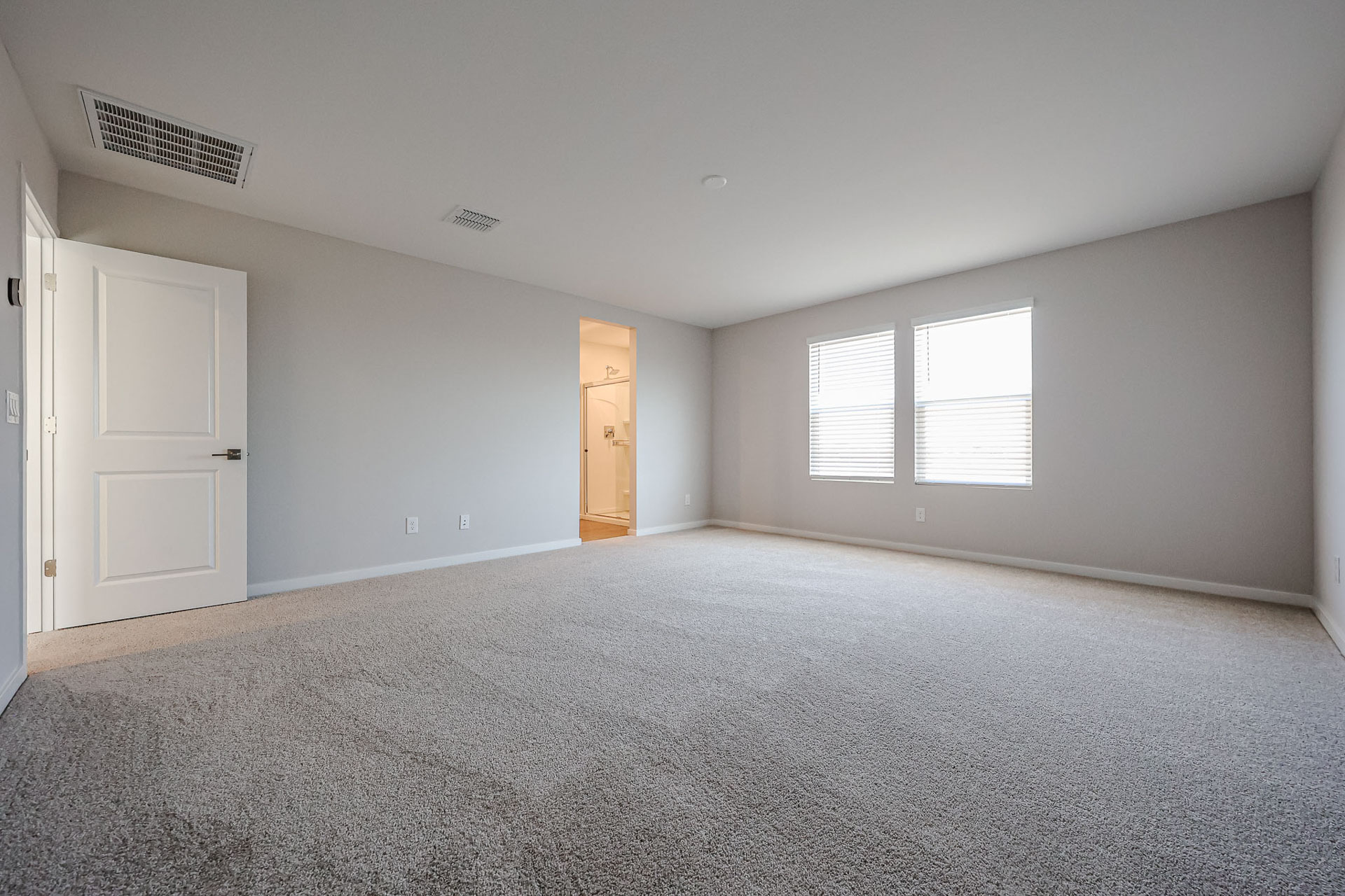 A room with white walls and a carpeted floor.