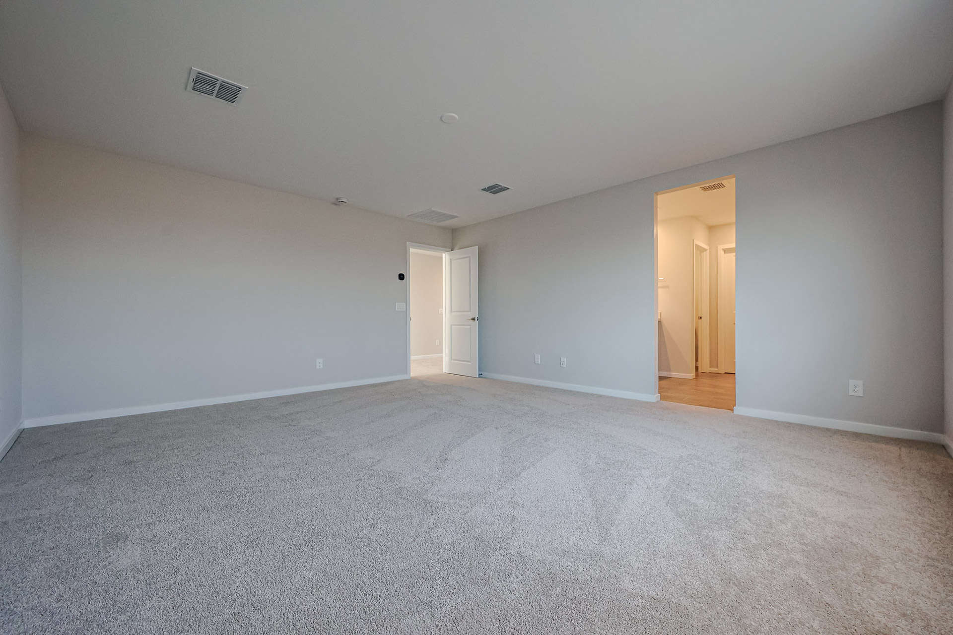 A room with white walls and doors.