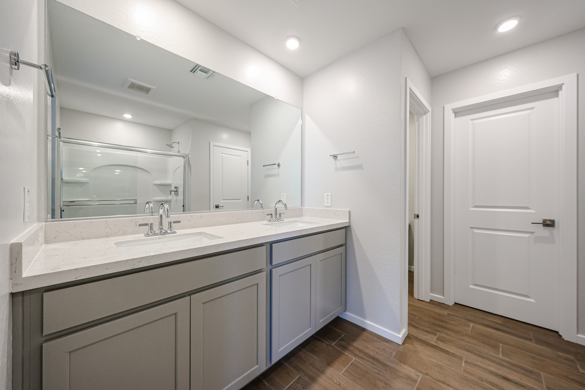 A bathroom with white cabinets.