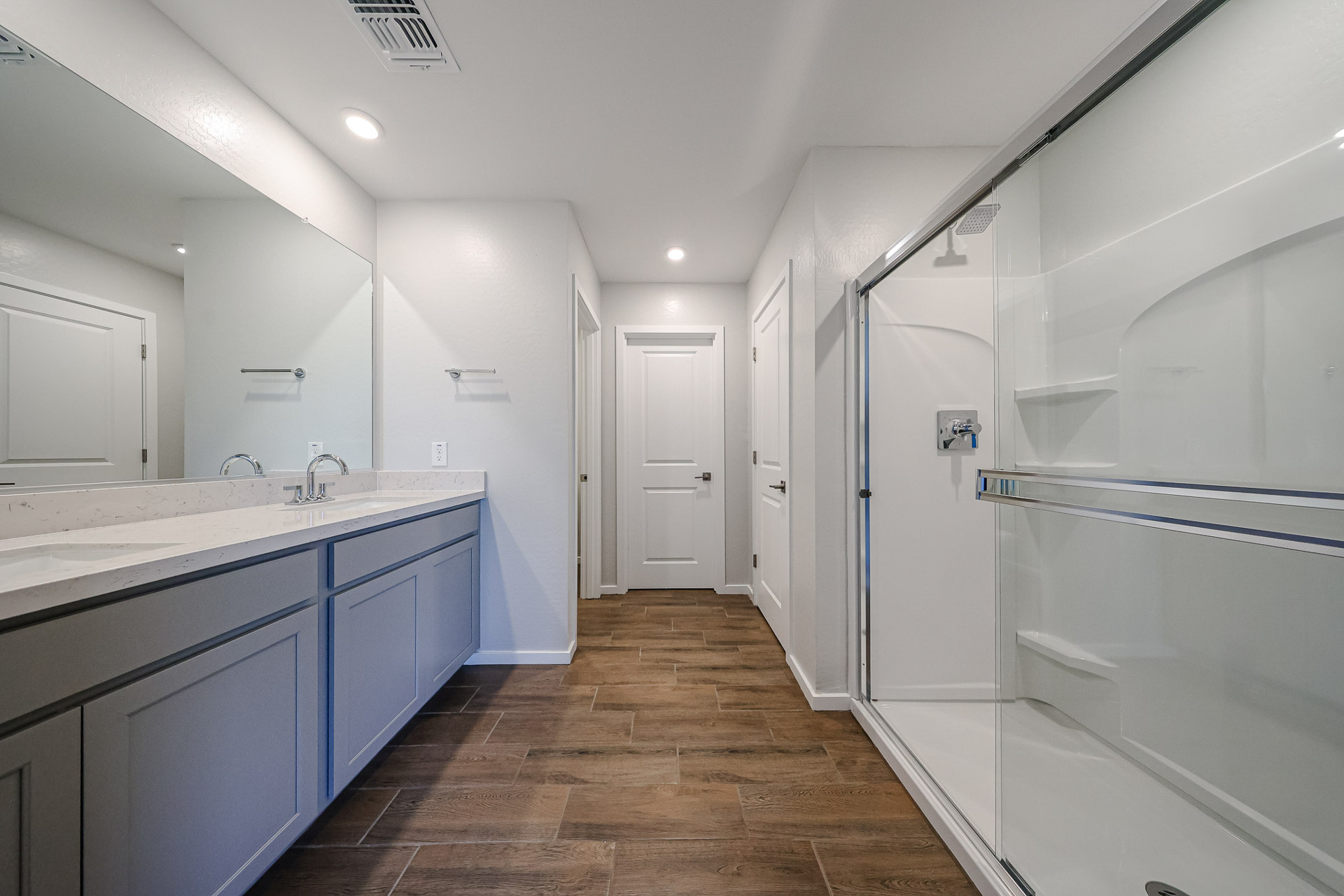A bathroom with white cabinets.