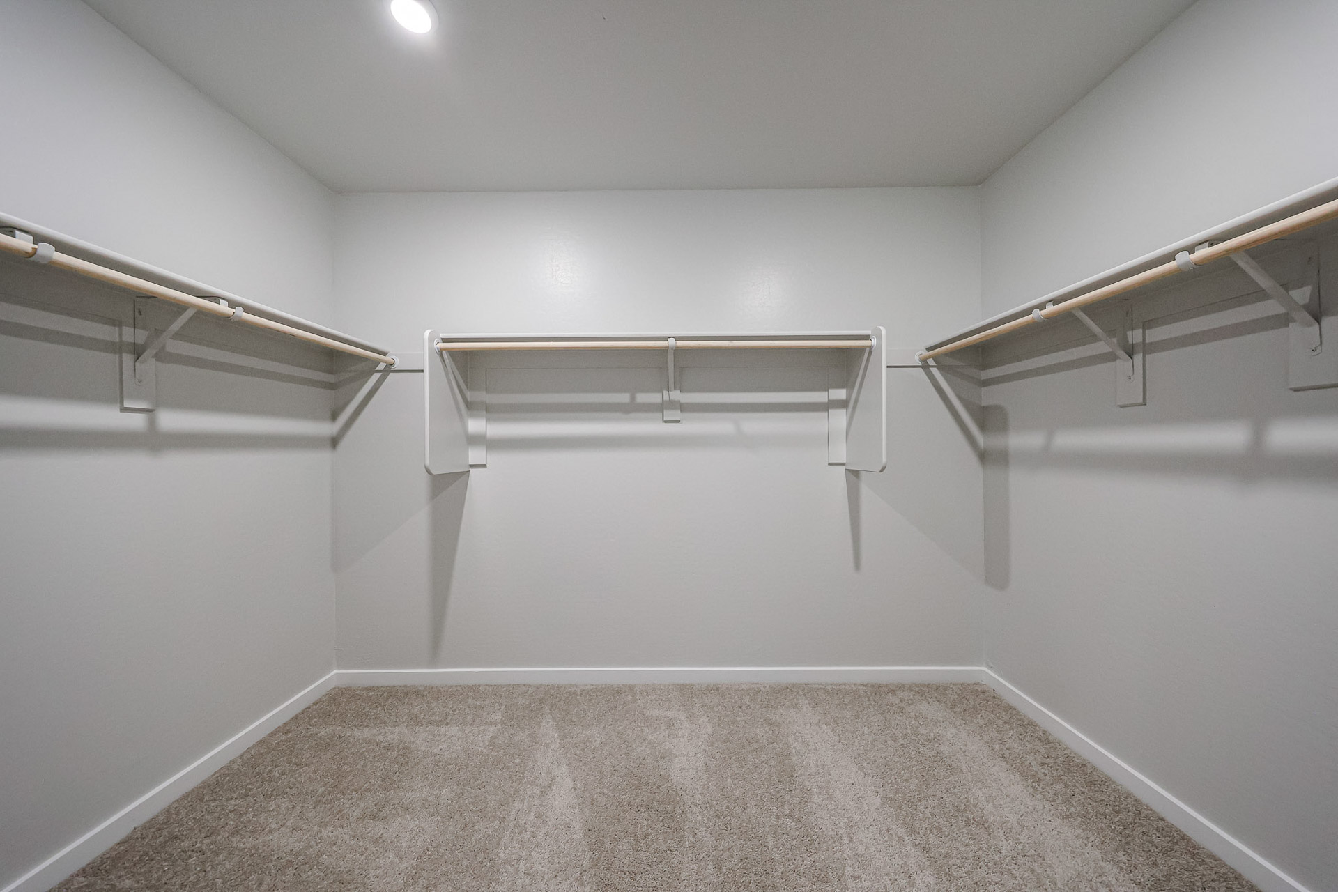 A white room with a metal railing.