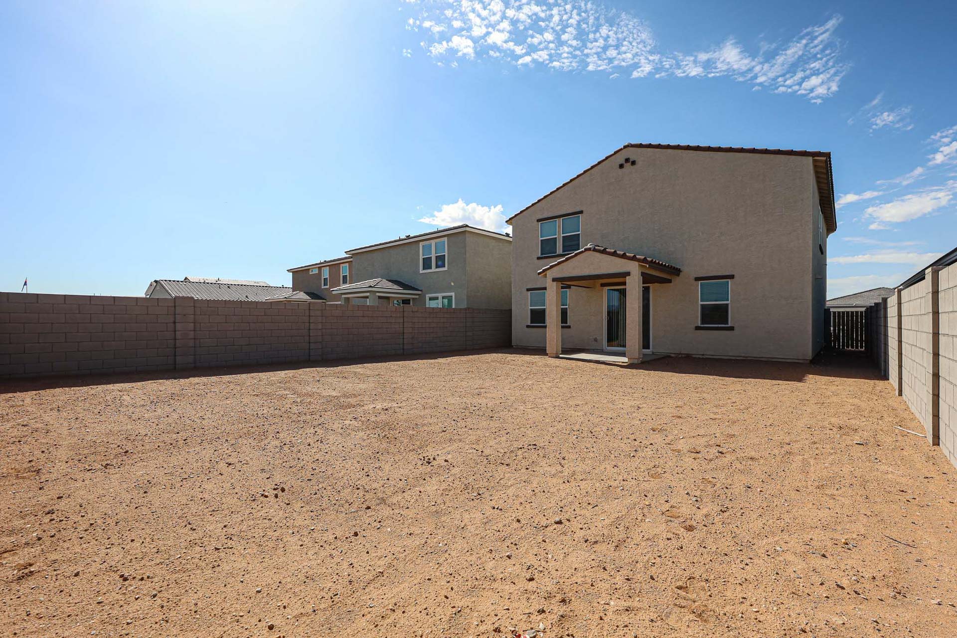 A building in a dirt field.