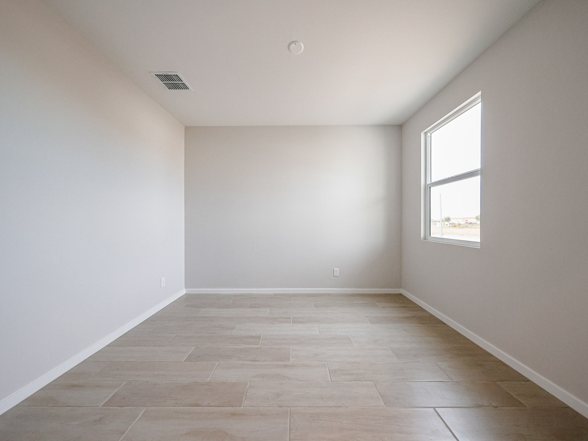 A room with a tile floor and a window.