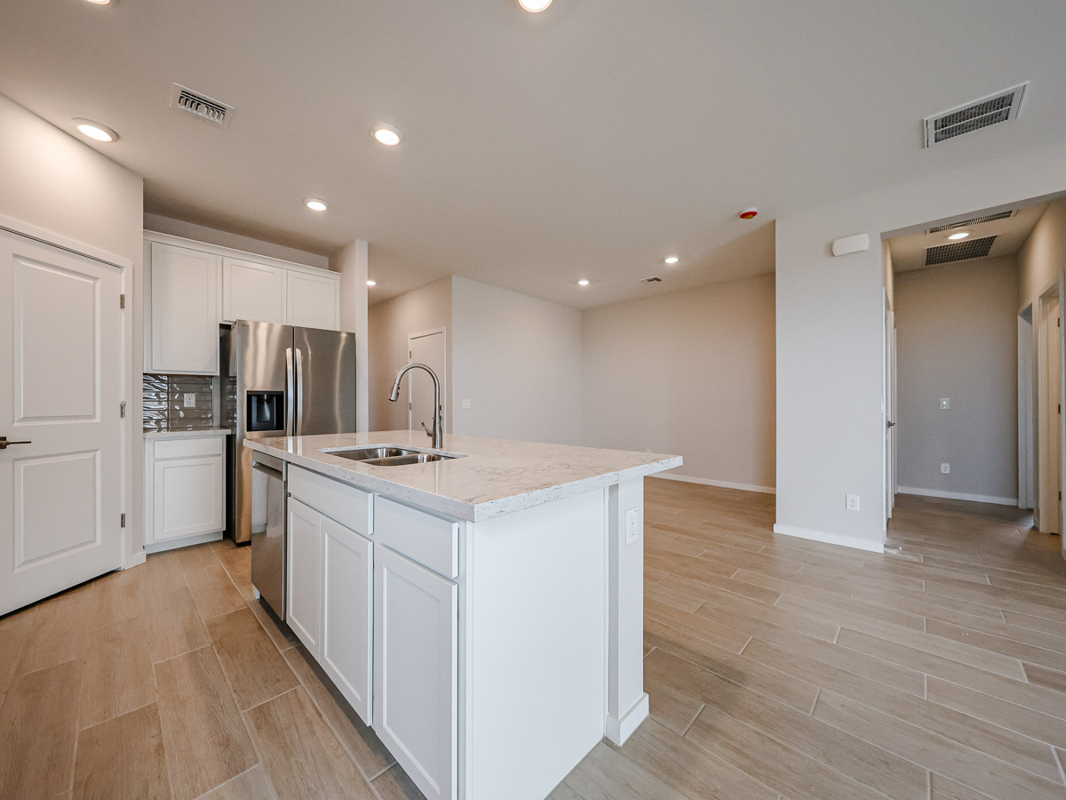 A kitchen with white cabinets.