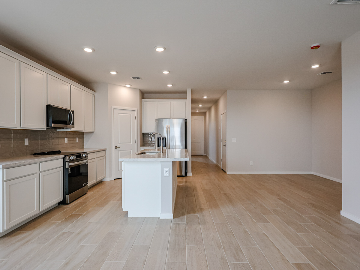 A kitchen with white cabinets.