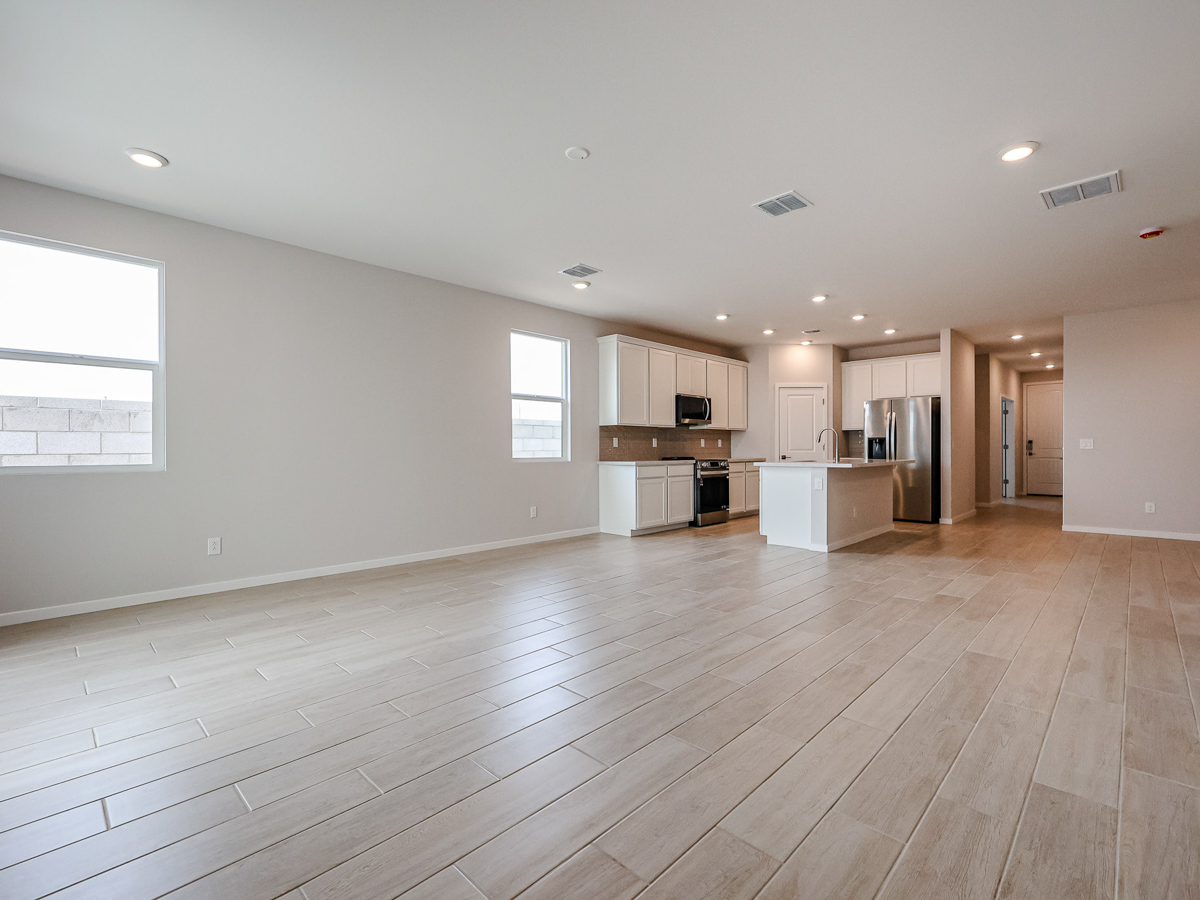 A large empty room with a wood floor and a wood floor.