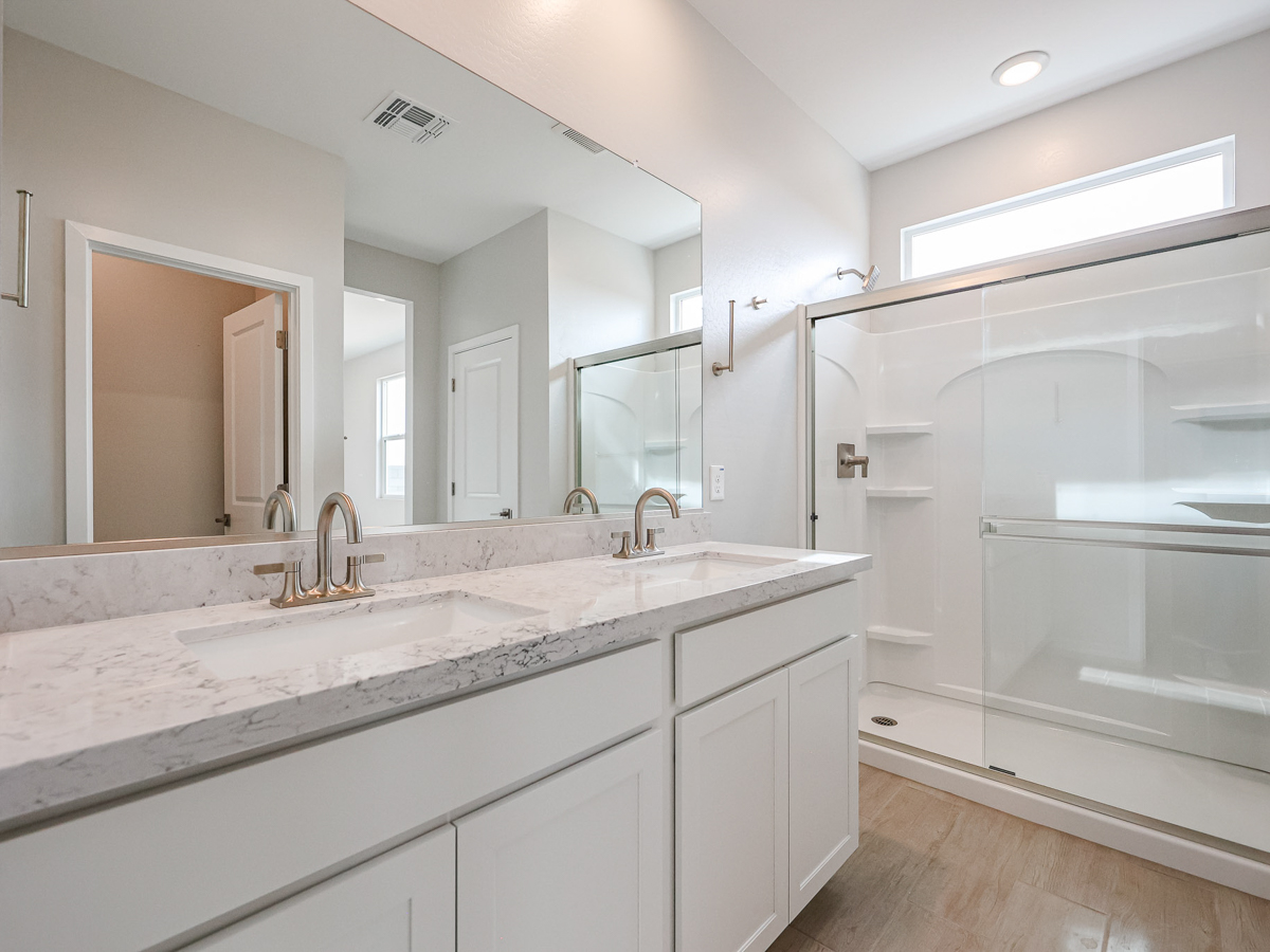 A bathroom with a large mirror.
