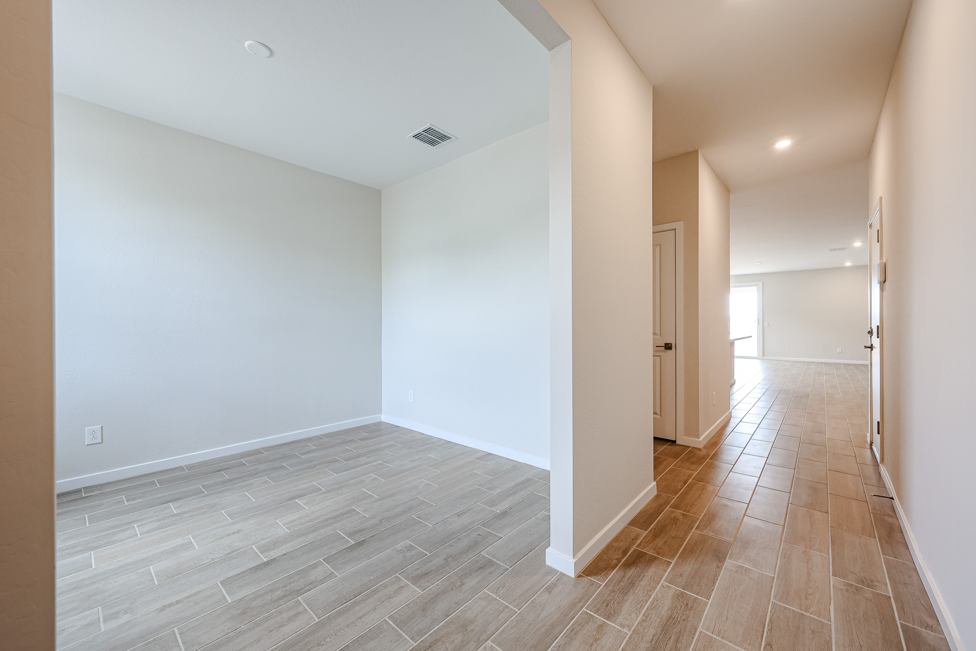 A hallway with white walls.