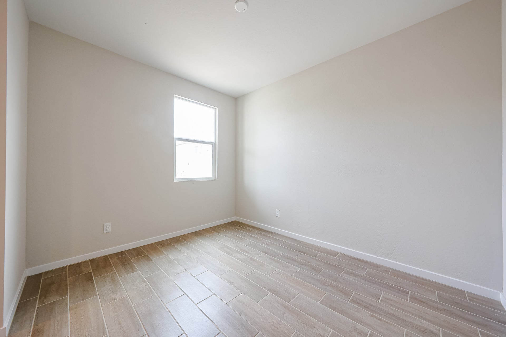 A room with a wood floor and a wood floor.