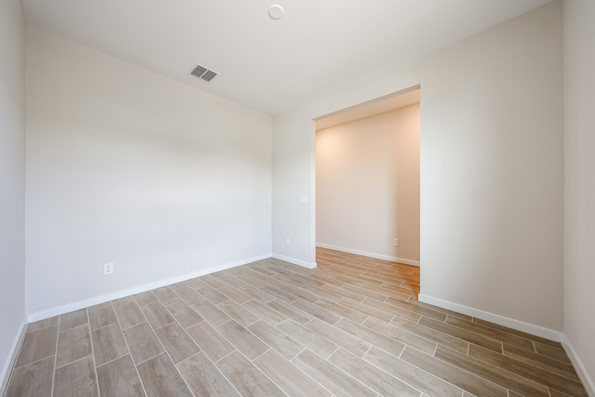 A room with a wood floor and a wood floor.
