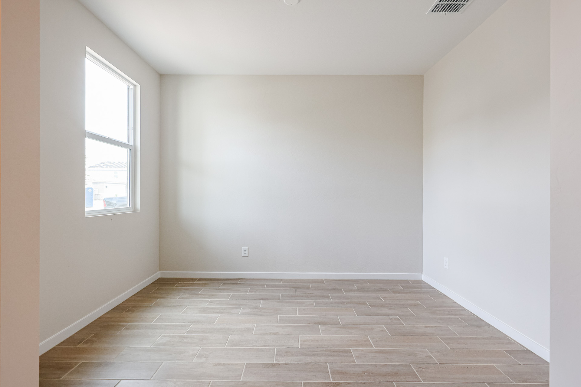 A room with a tile floor and windows.
