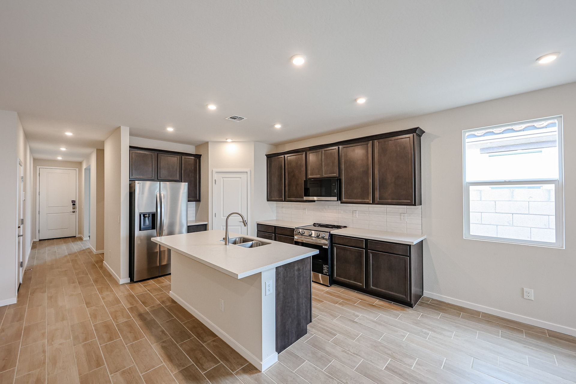 A kitchen with black cabinets.