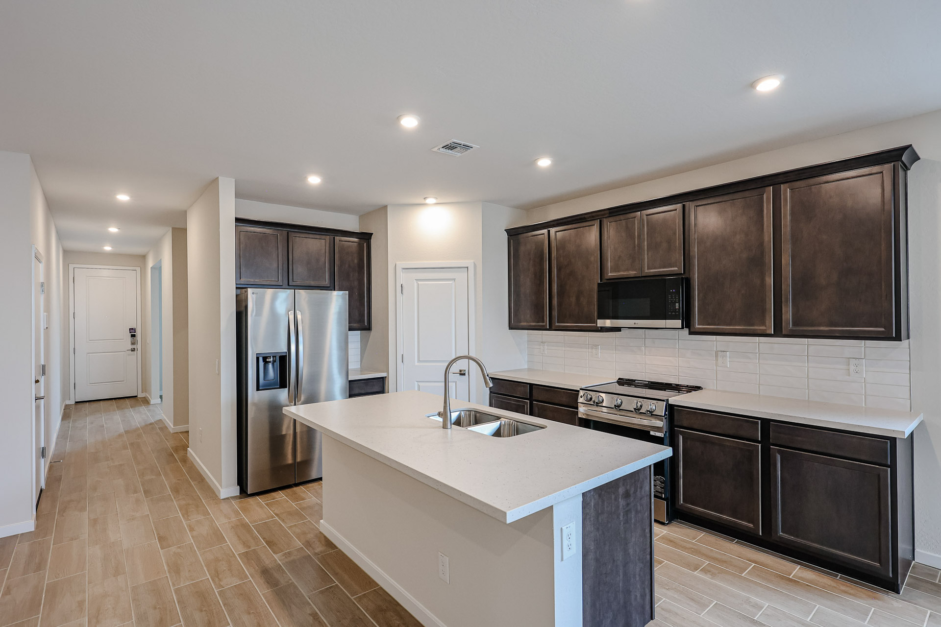 A kitchen with black cabinets.