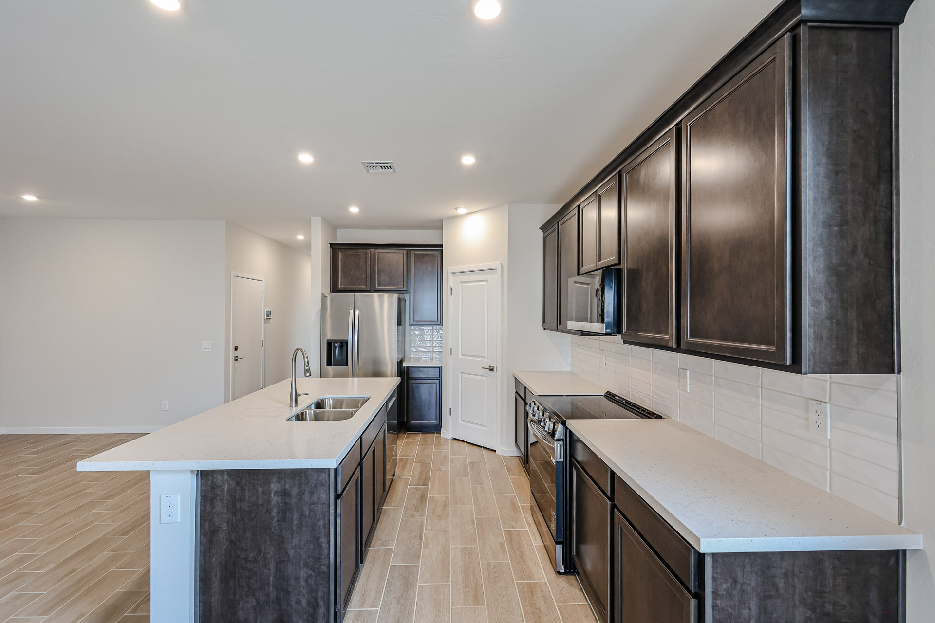 A kitchen with black cabinets.