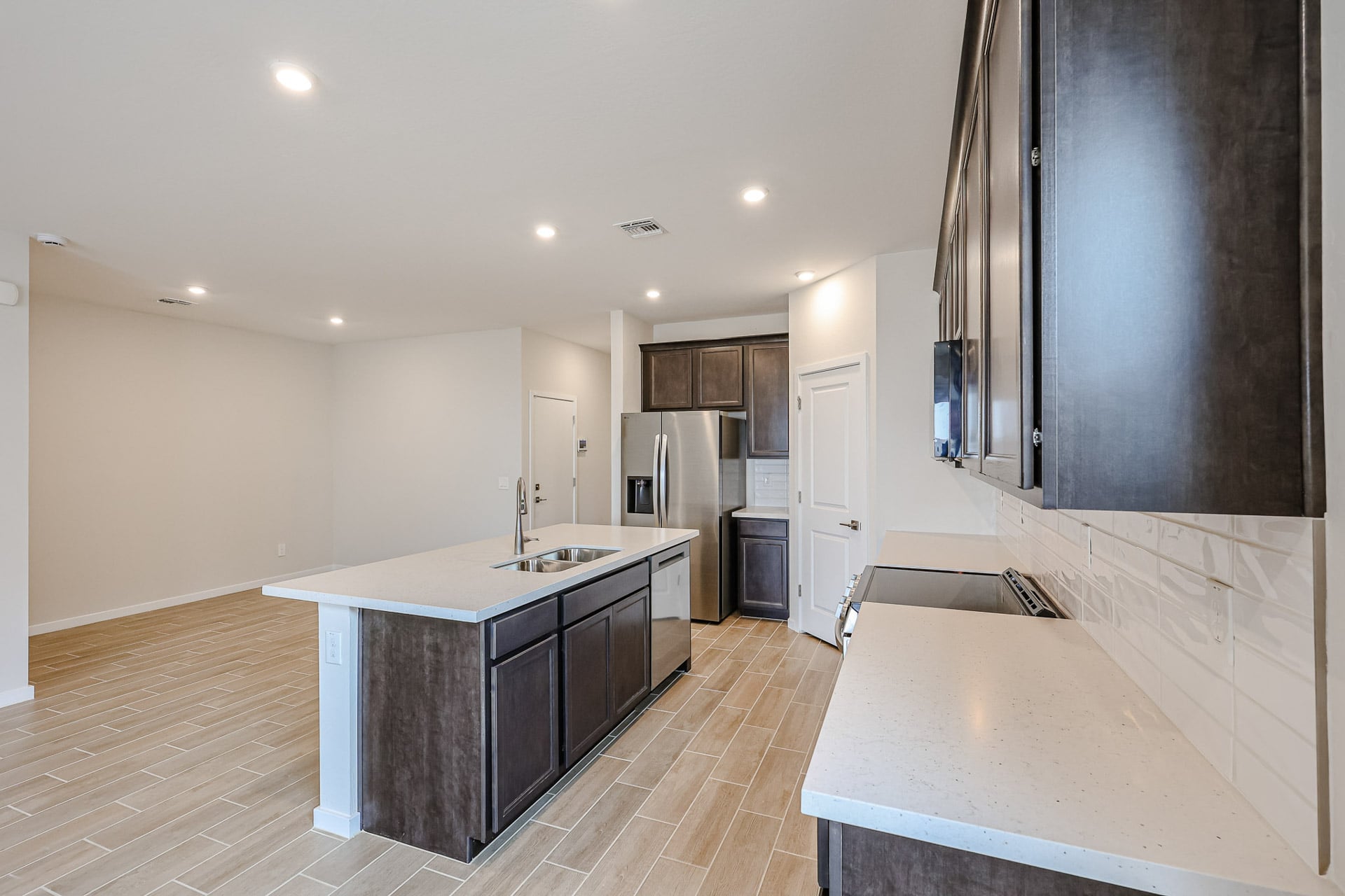 A kitchen with a bar and a bar stool.