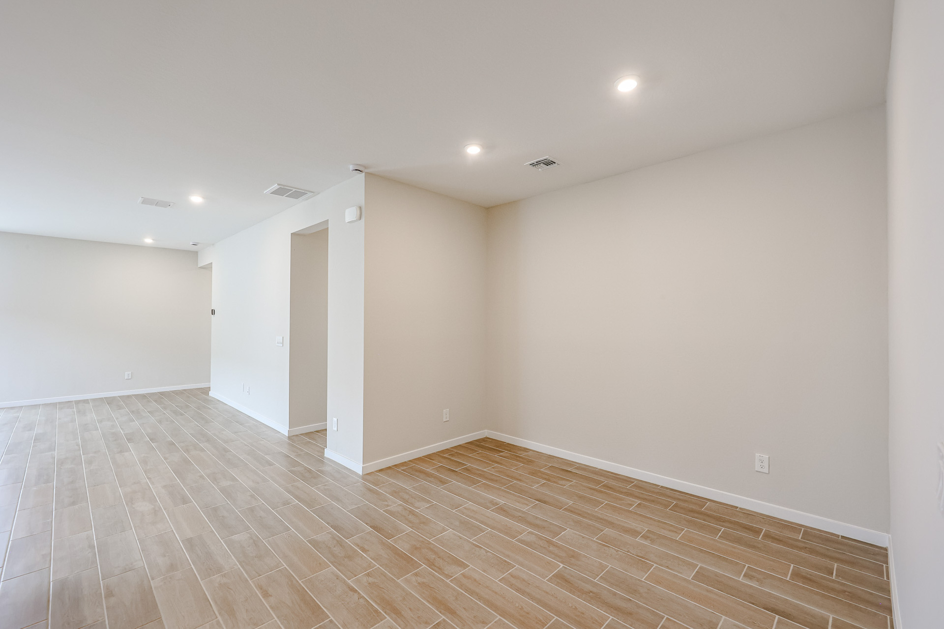 A room with a wood floor and white walls.
