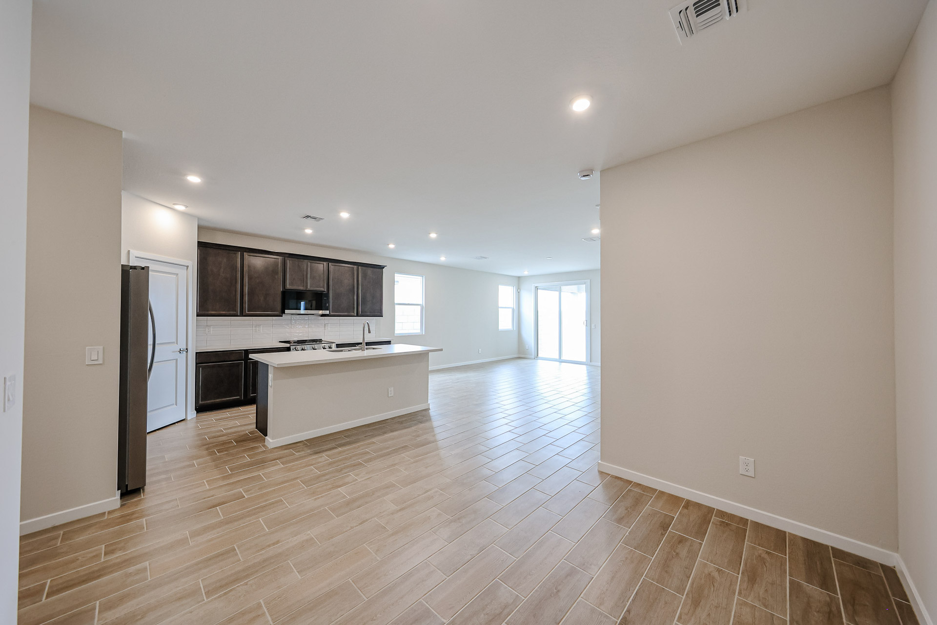 A large kitchen with wood floors.