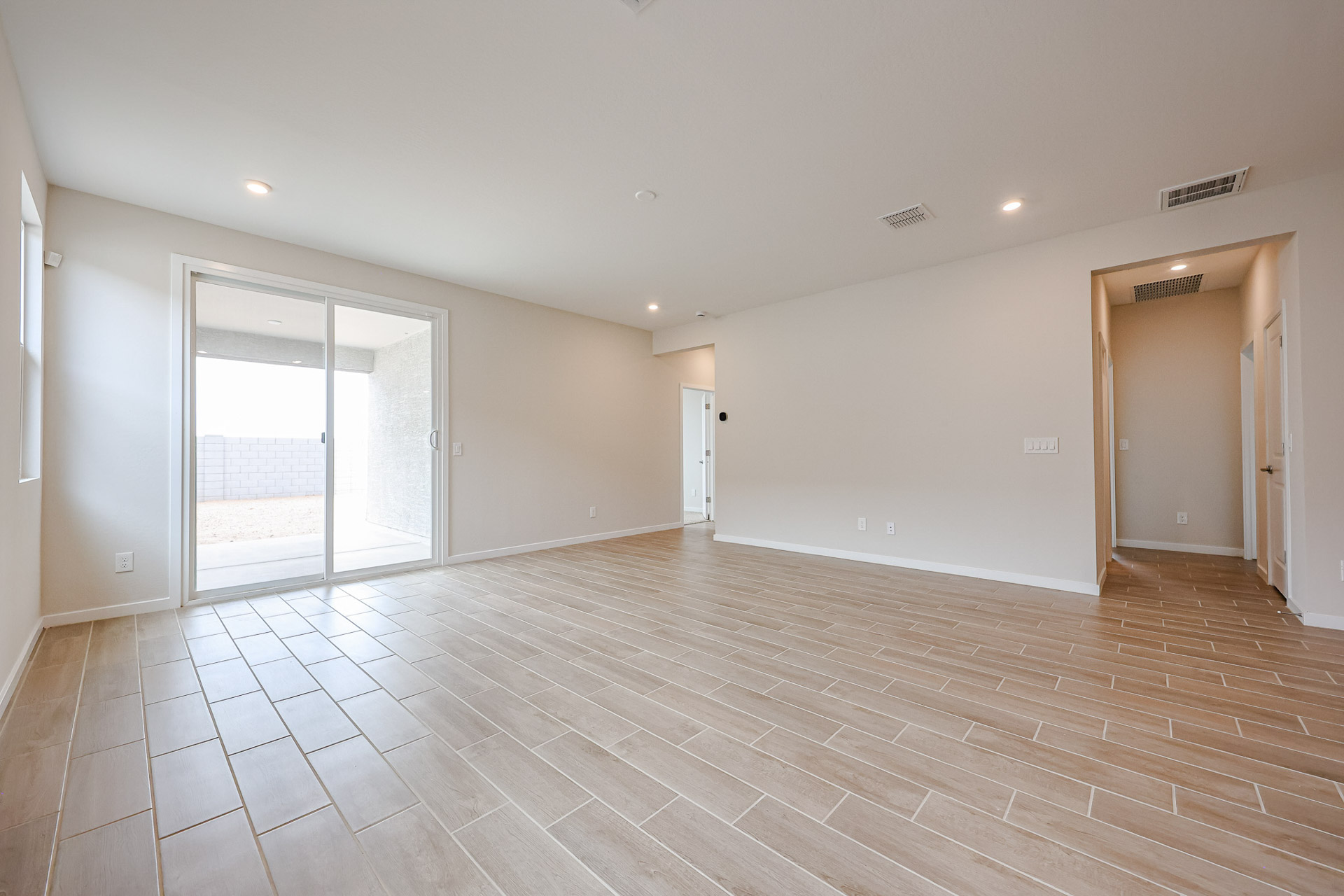 A room with a wood floor and white walls.