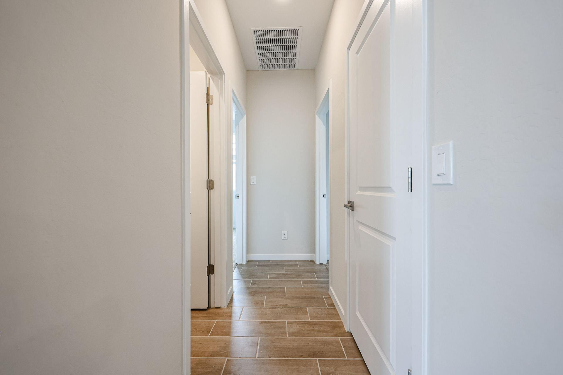 A hallway with white doors.