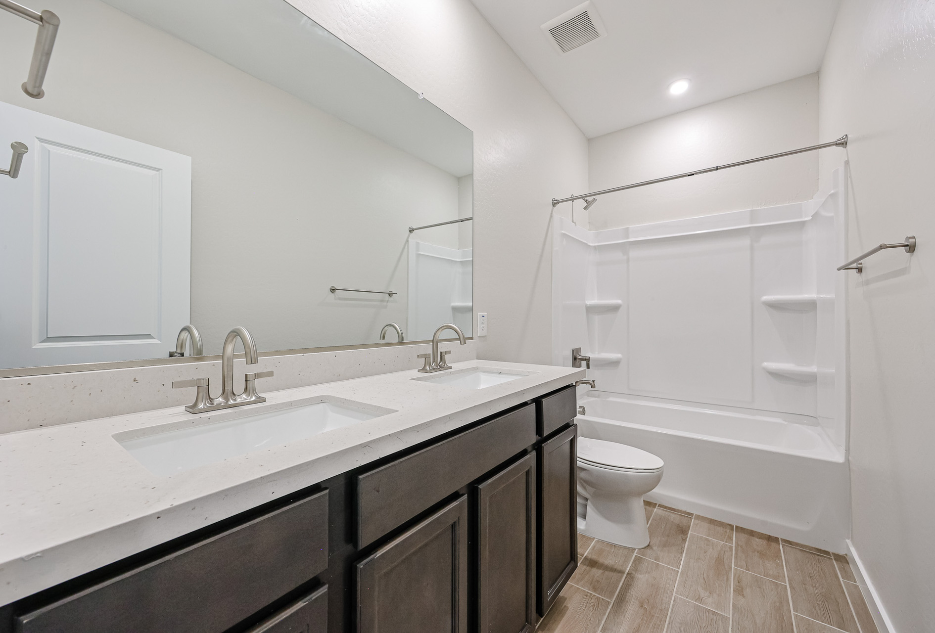 A bathroom with a tub sink and toilet.