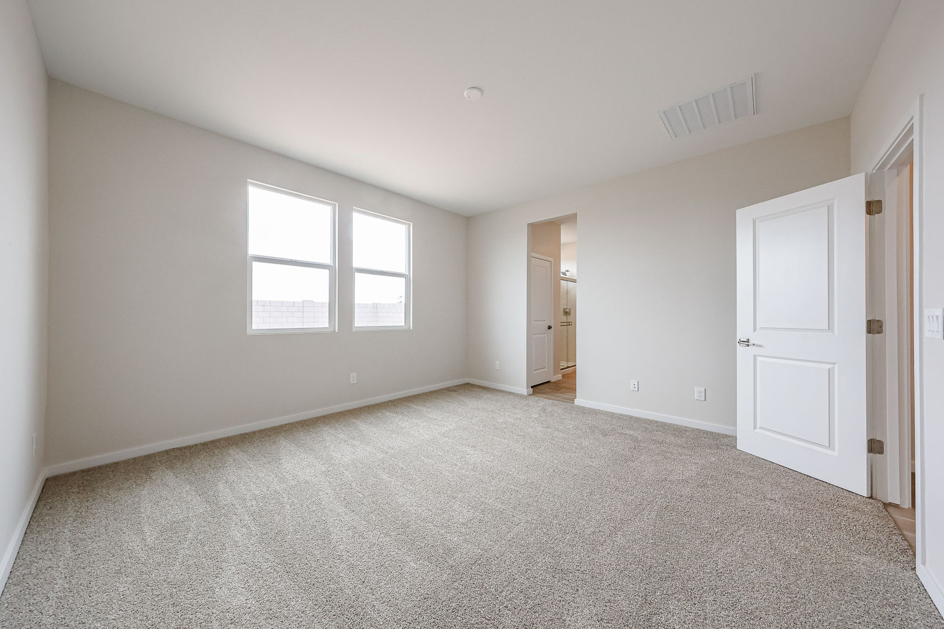A room with white walls and a carpeted floor.