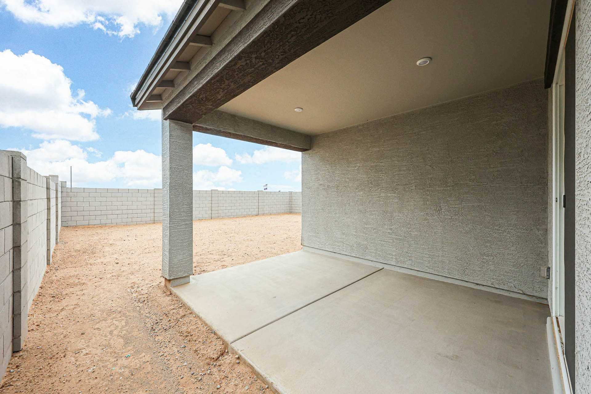A concrete walkway with a concrete wall.