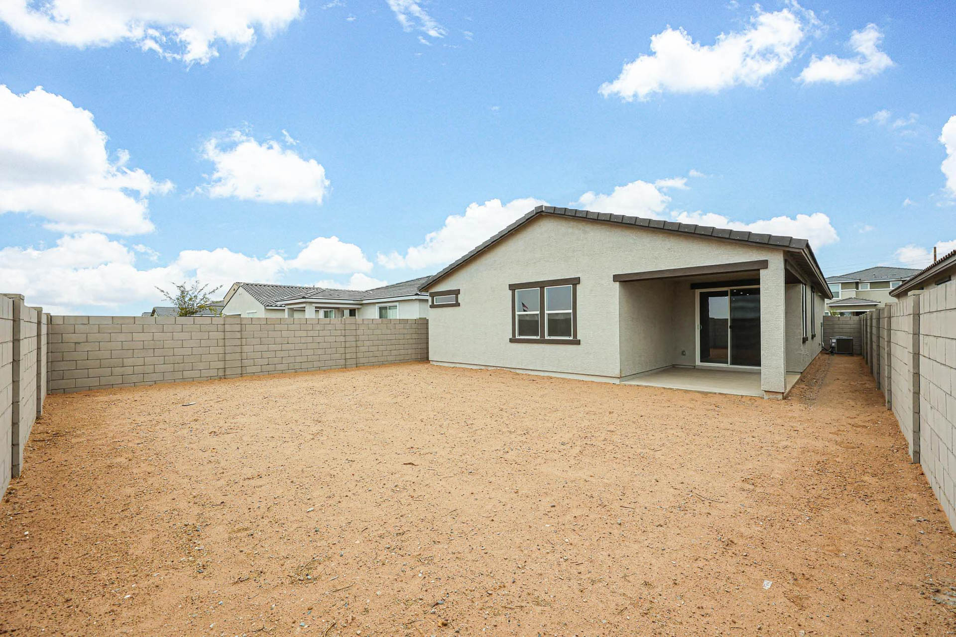 A dirt yard with a house.