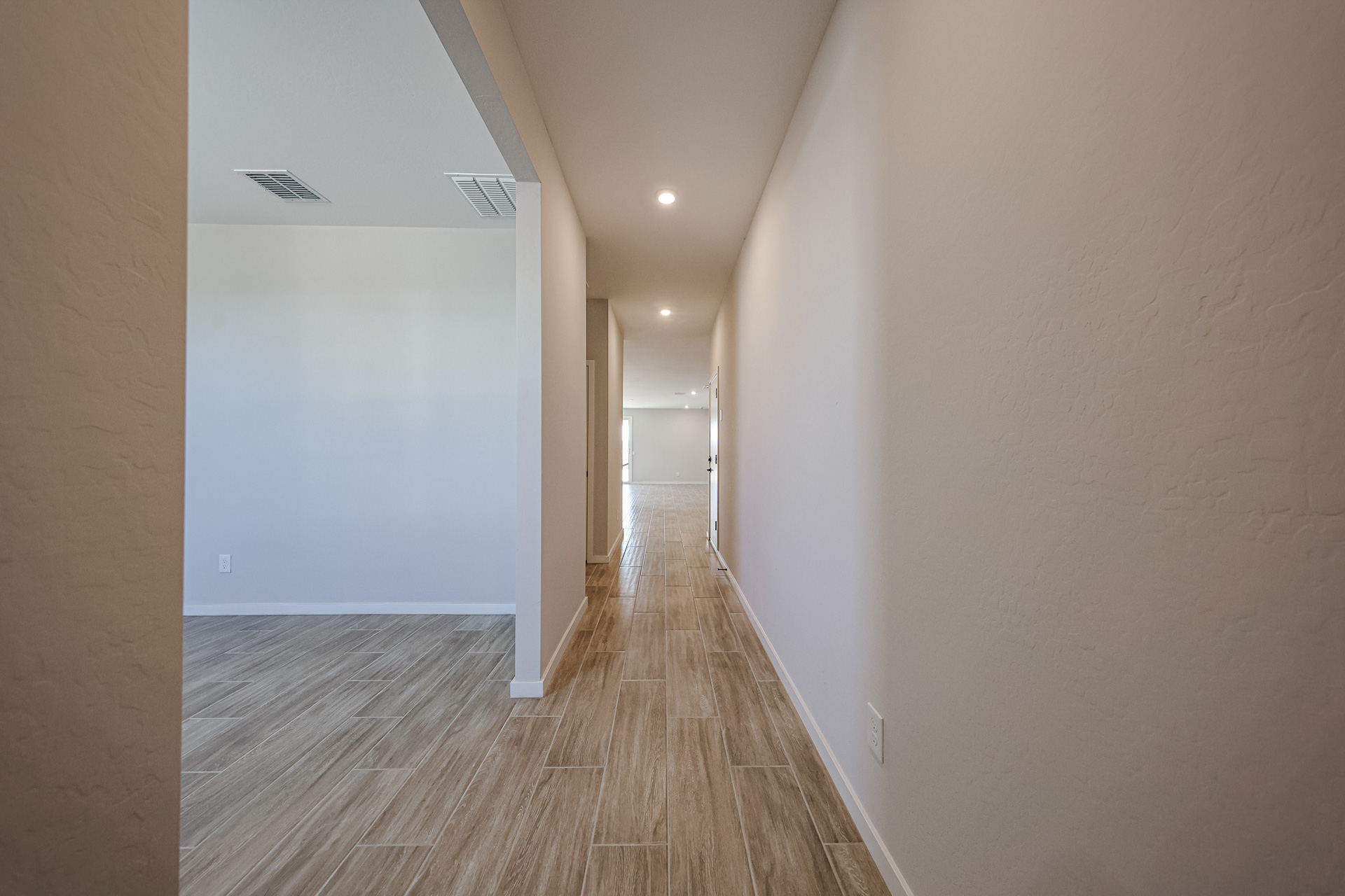 A long hallway with white walls.