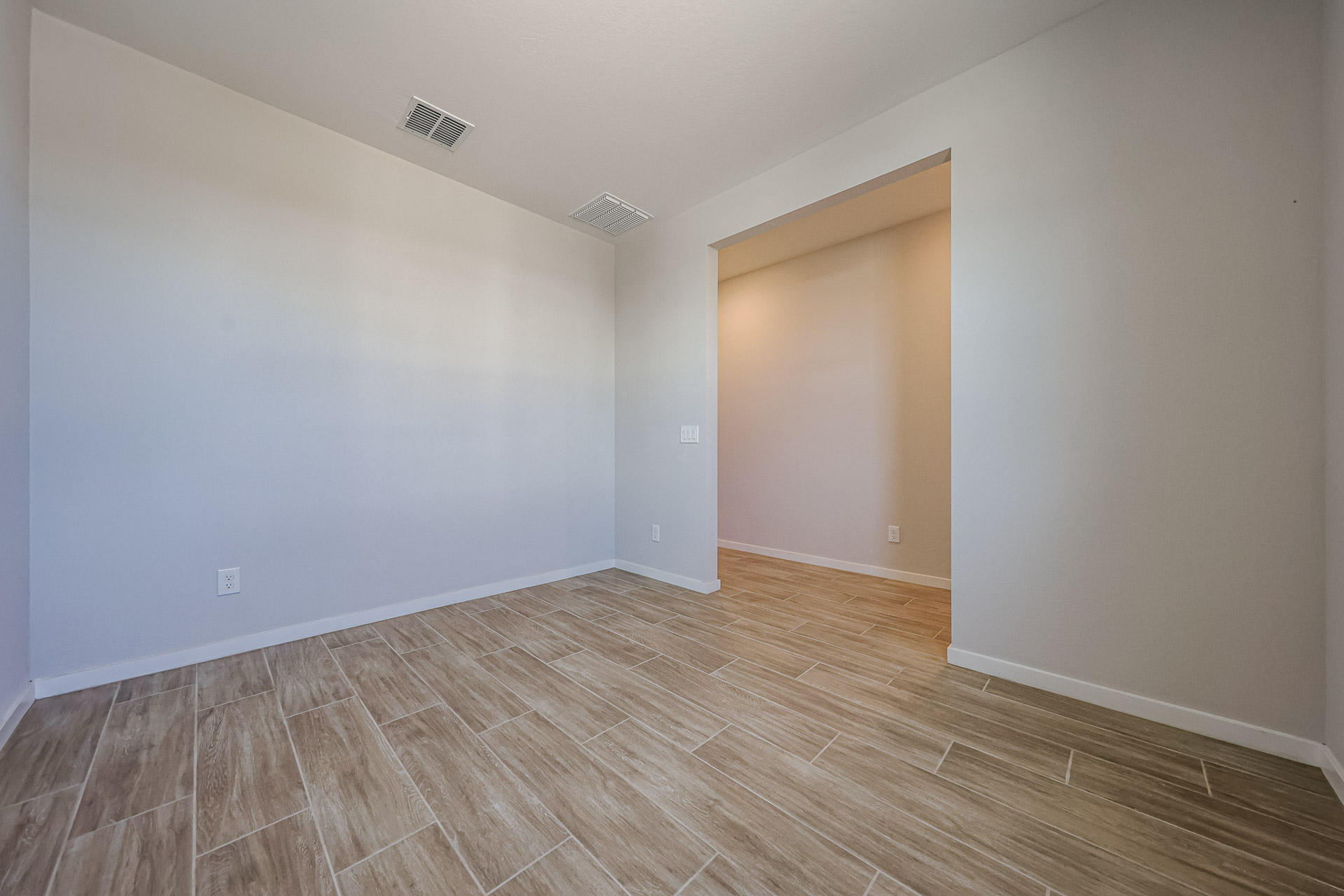 A room with a wood floor and a wood floor.