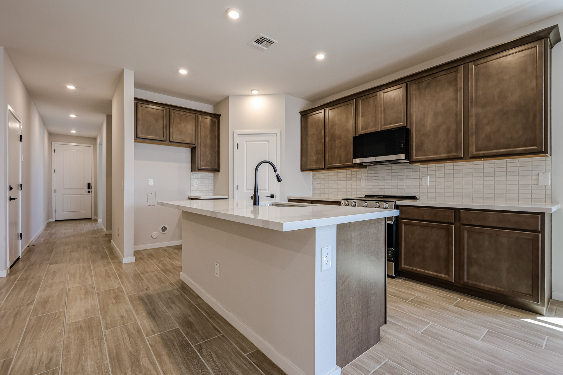 A kitchen with wooden cabinets.