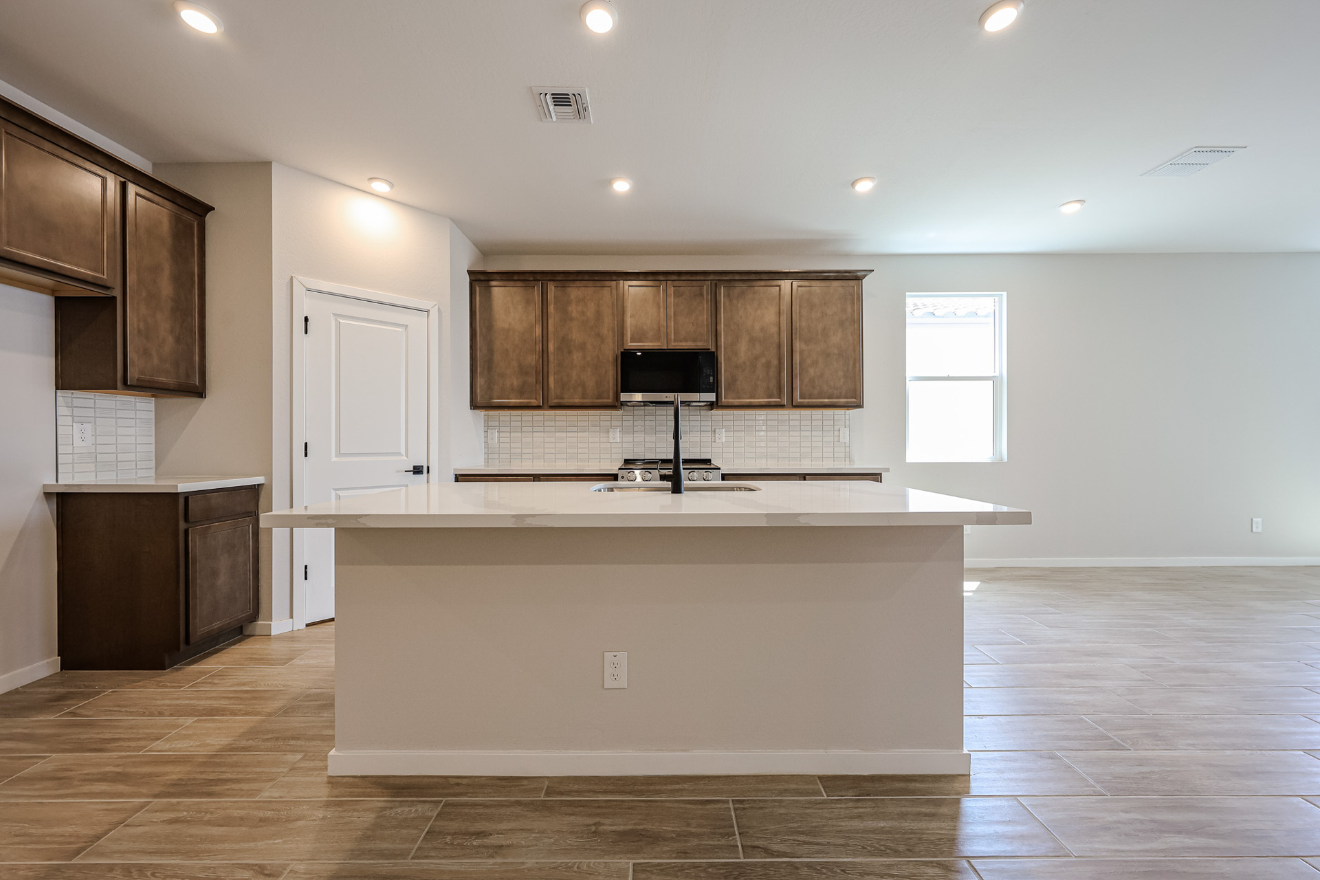A kitchen with wooden cabinets.