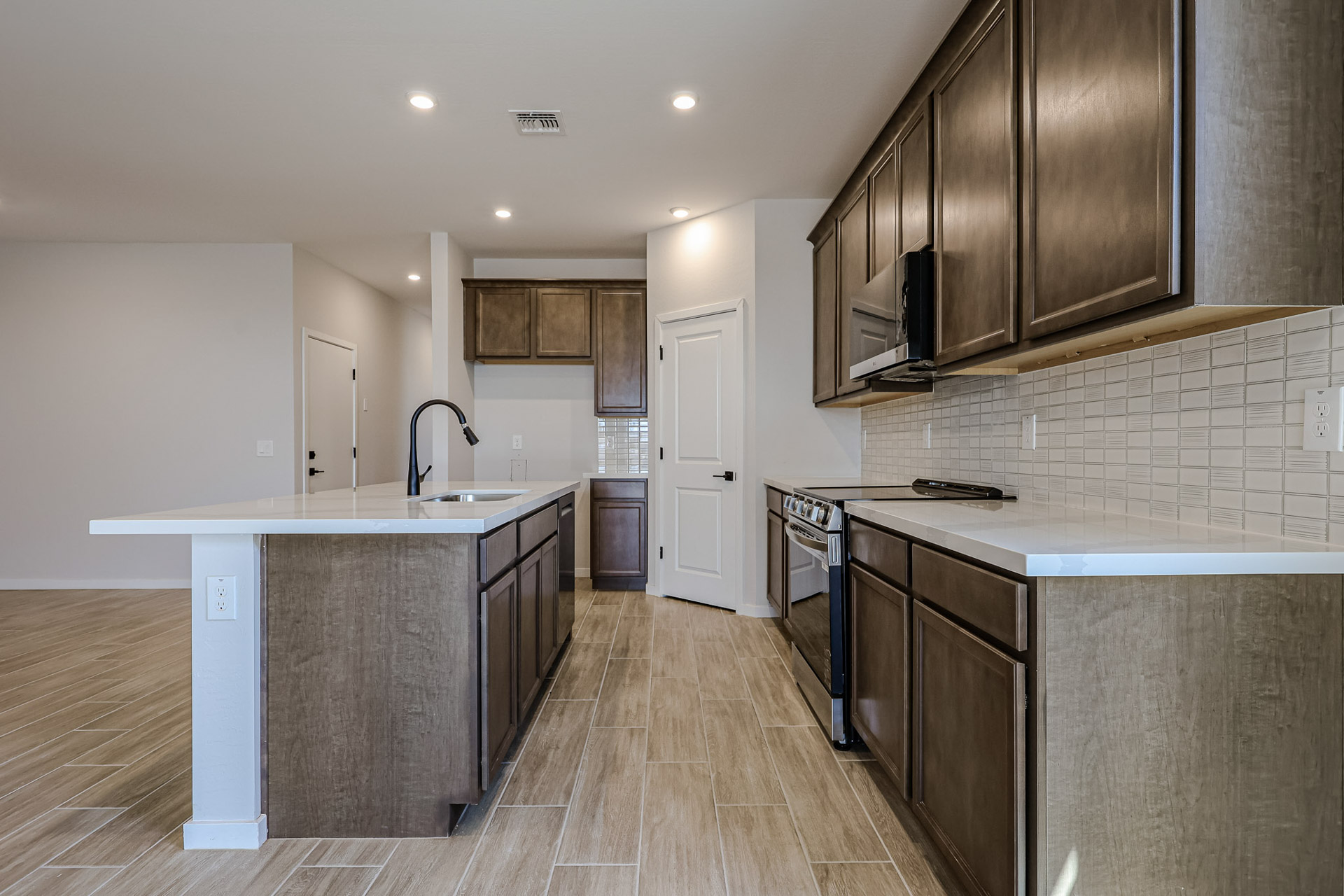 A kitchen with wooden cabinets.