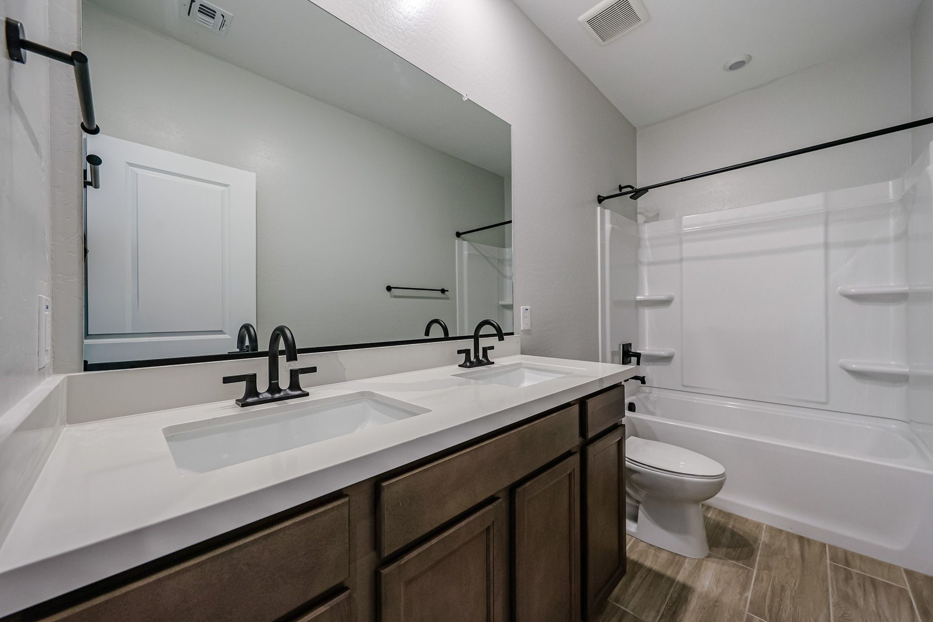 A bathroom with a tub sink and toilet.