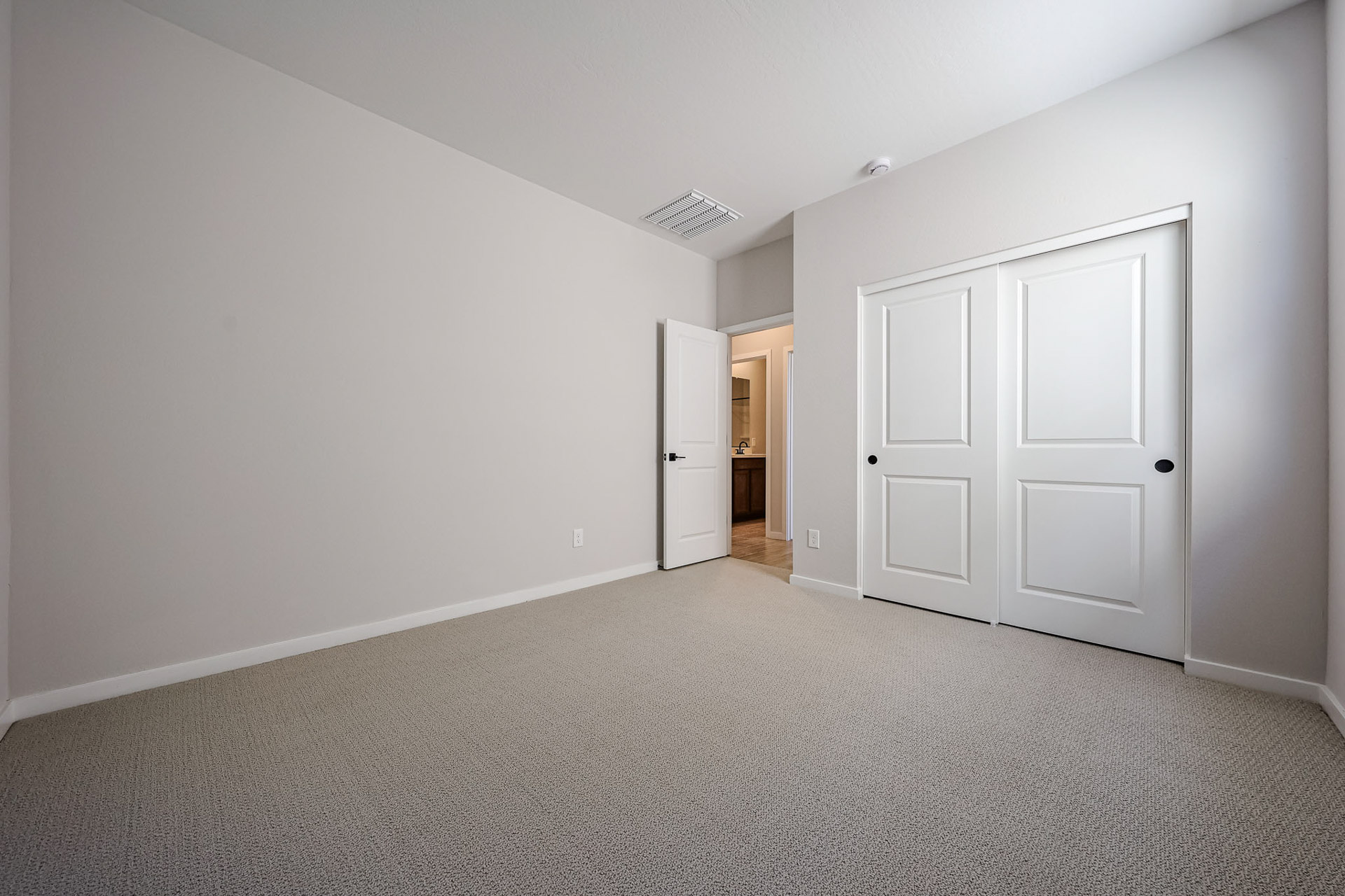 A hallway with white doors.