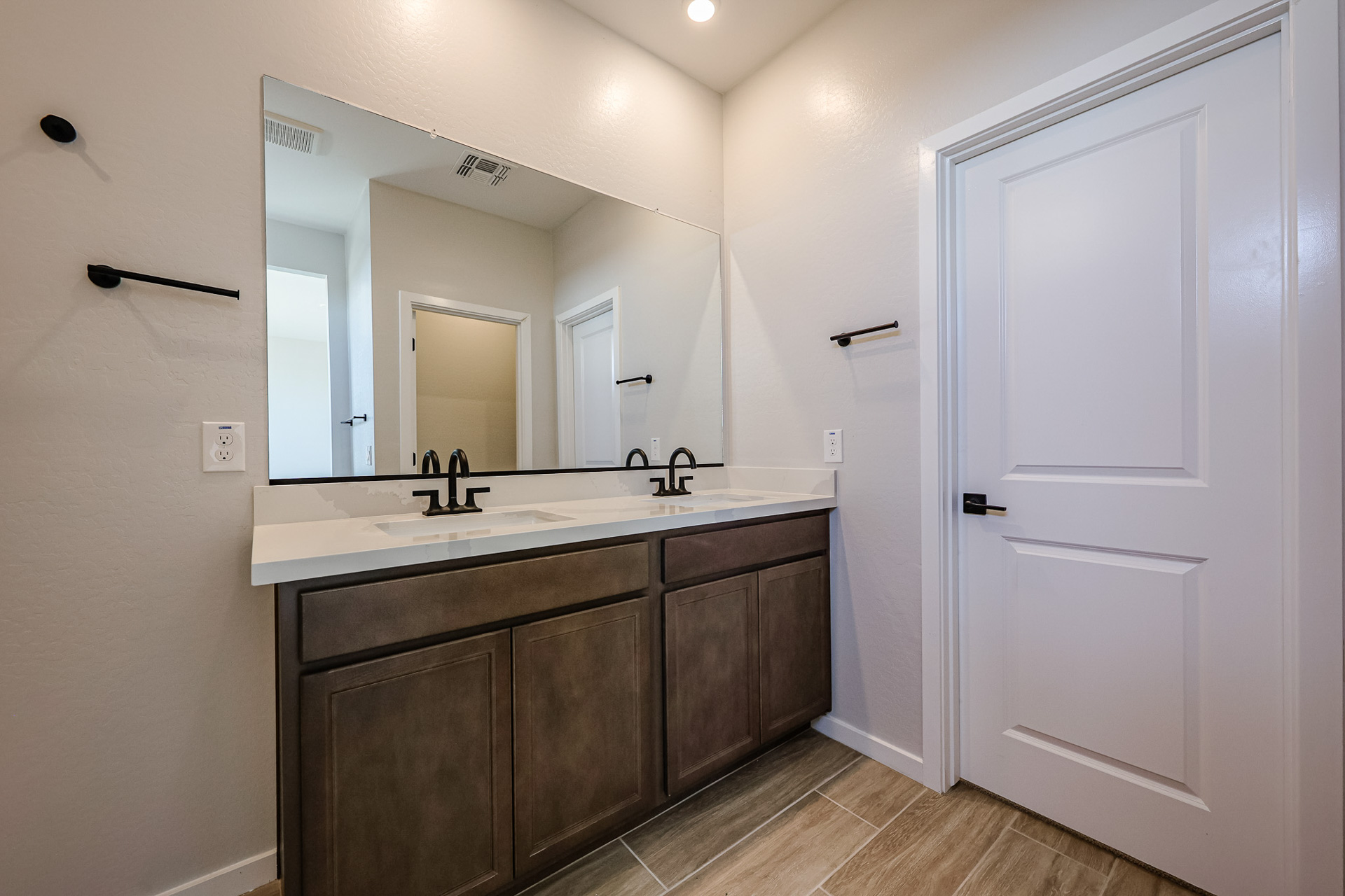 A bathroom with a large mirror.